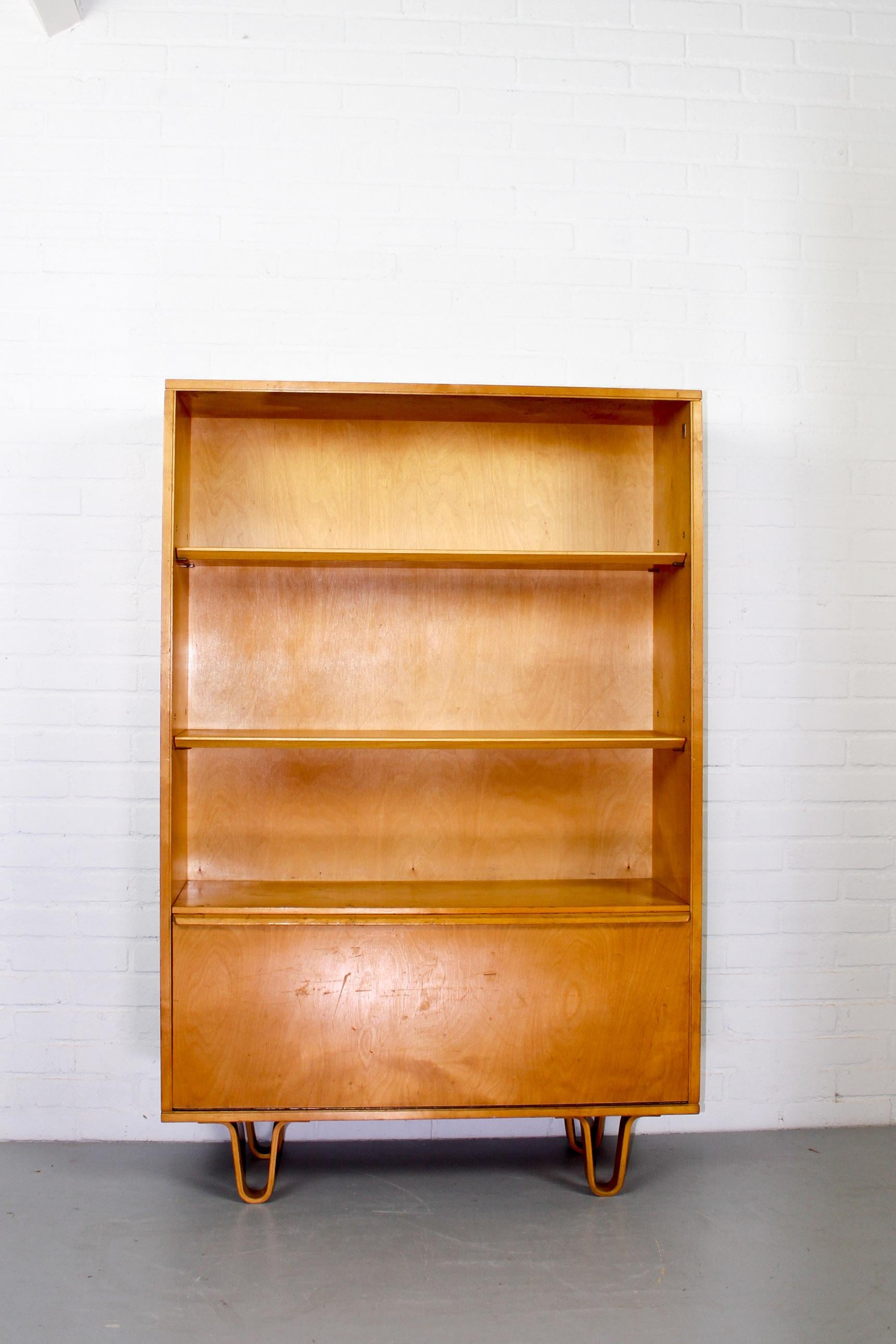 Birch series bookcase by Cees Braakman for Pastoe. The Birch series are famous for their bended legs. A design from the 1950s and very collectible these days. This bookcase is in a good condition with some user marks from age and use. It is marked