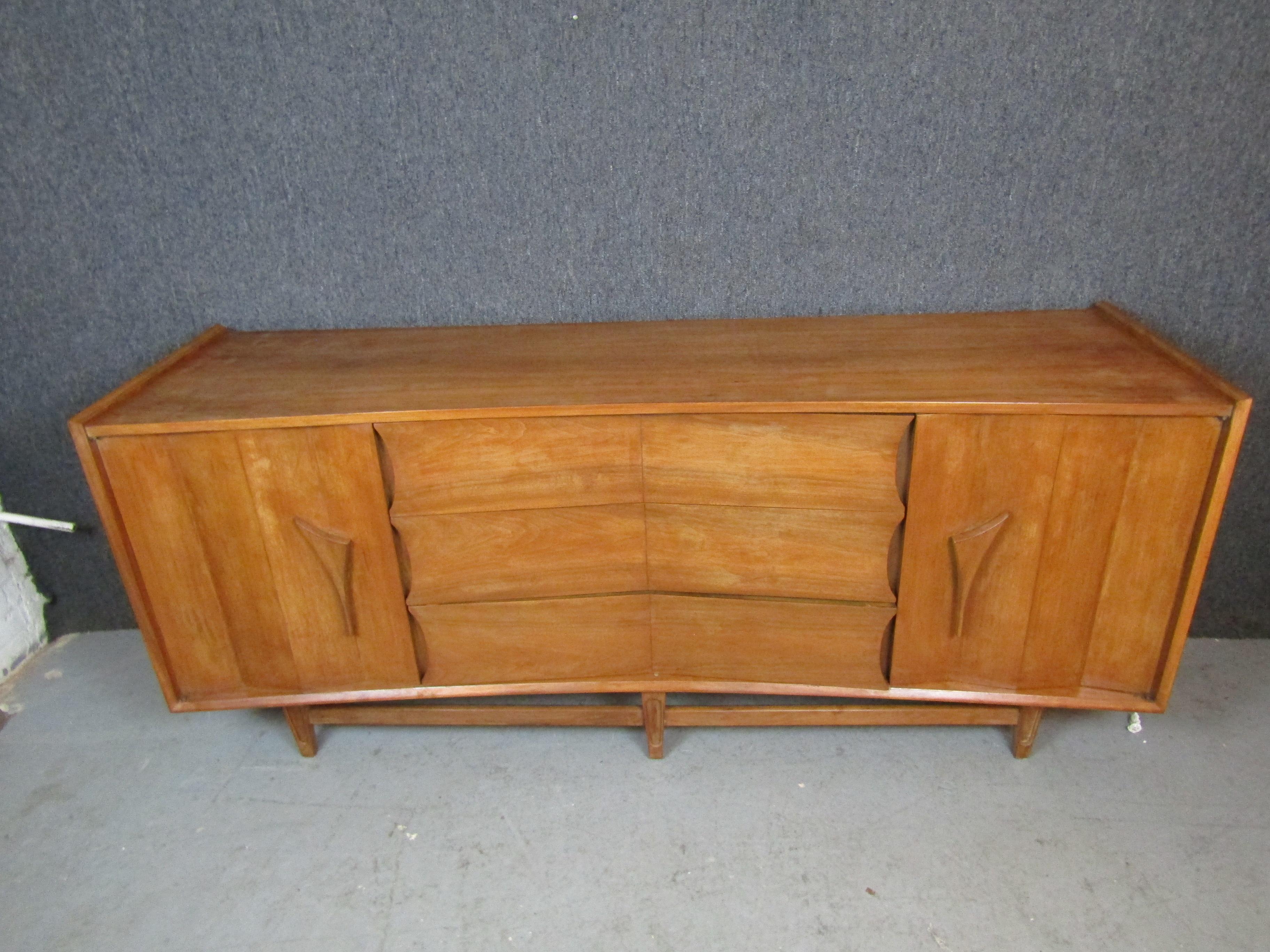 Bring home the artisanal craftsmanship that made mid-century Scandinavian furniture the envy of the world with this beautiful curved credenza from Sweden's Karlit Möbelfabriken. Wonderful carved details give this piece a funky modern feel