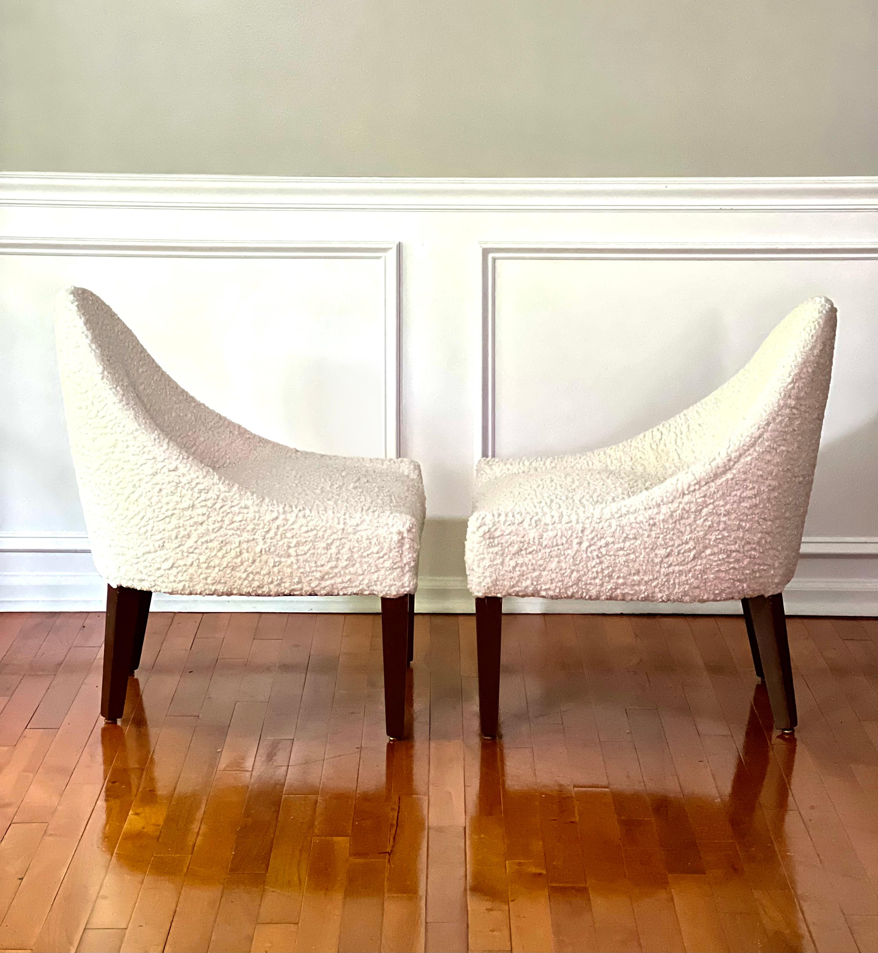 Vintage midcentury bouclé Zoey slipper chairs, a pair.

Wonderful pair of comfortable, low profile slipper chairs with beautiful design. The curved back gracefully flows into the low arm rest and seat. Newer upholstery in ivory bouclé is in