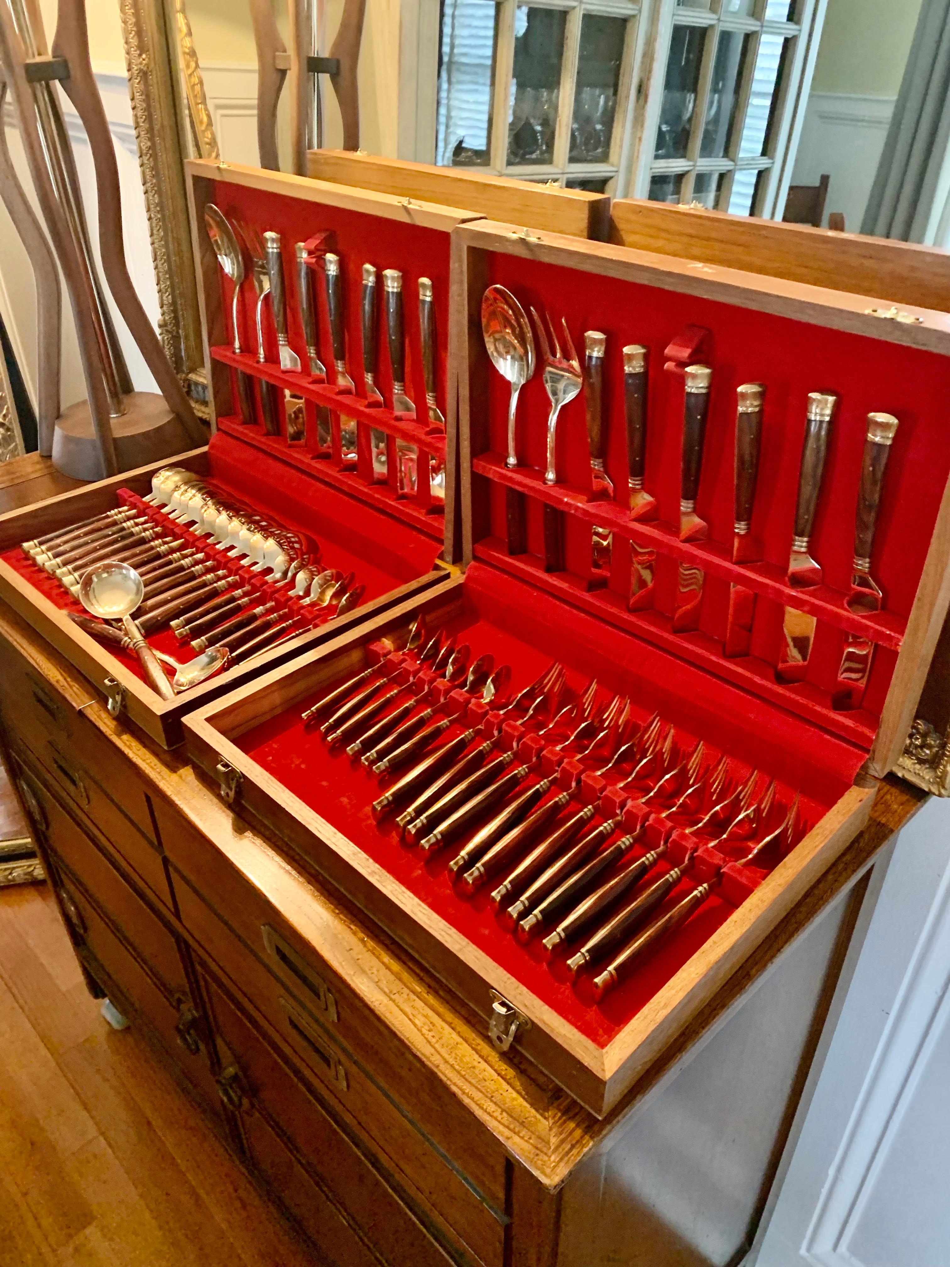 Vintage brass and rosewood flatware set with serving pieces. Set includes:
12 Dinner forks
12 Knives
12 Tablespoons
12 Teaspoons
2 Serving spoons
2 Smaller round serving spoons
2 Serving forks

54 pieces total. Set is in great condition