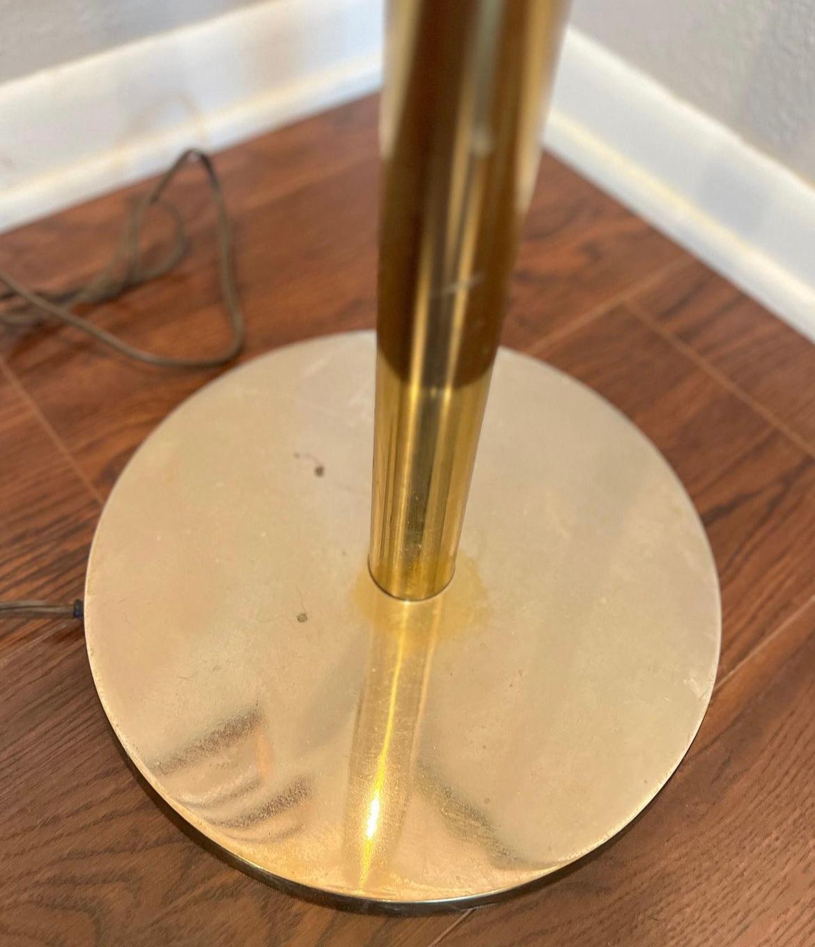 Vintage mid century brass torchiere tall floor lamp by Laurel Lamp Company. Features a minimalist tall design with a fluted trumpet opening. Beautiful scale and proportions. In vintage working condition with light scratches and brass has faded