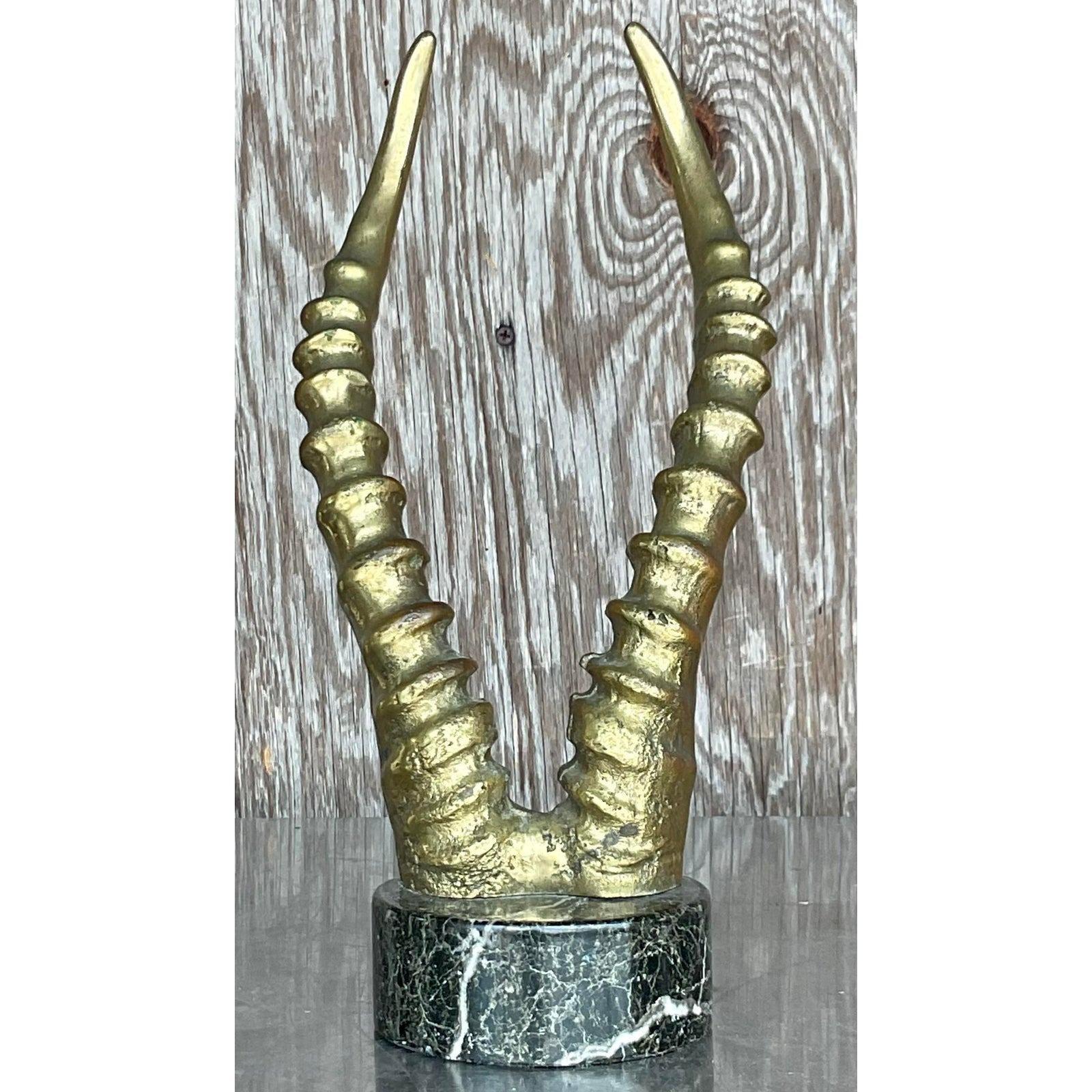 A stunning vintage sculpture of bronze antelope horns sculpture on a marble stand. Acquired at a Palm Beach estate.