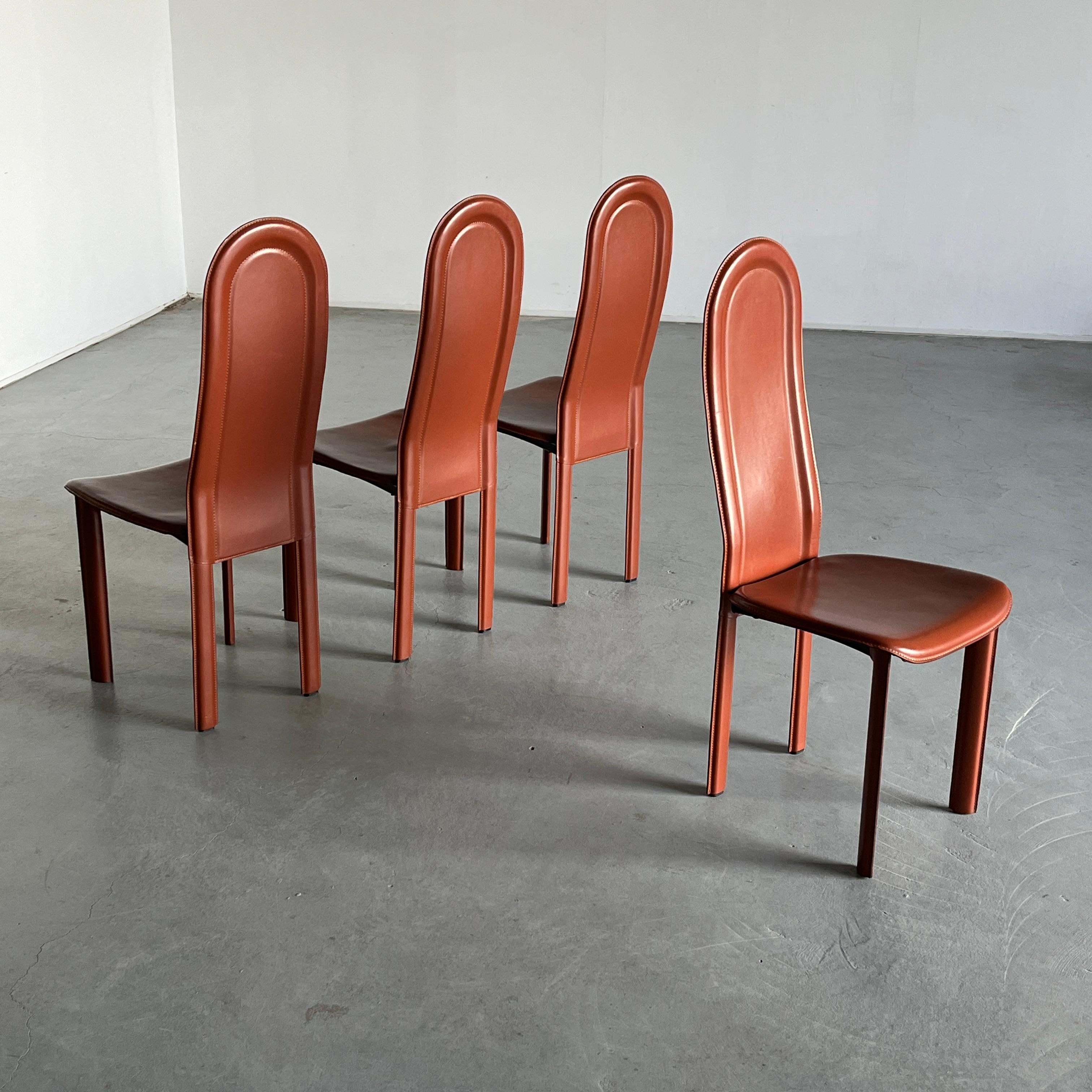 One of four high backrest dining chairs upholstered in brown leather. Reminiscent of designs by Roche Bobois and Cidue.

Manufactured in the 1980s in Italy.

In good vintage condition with smaller expected signs of age. Some horizontal marks are