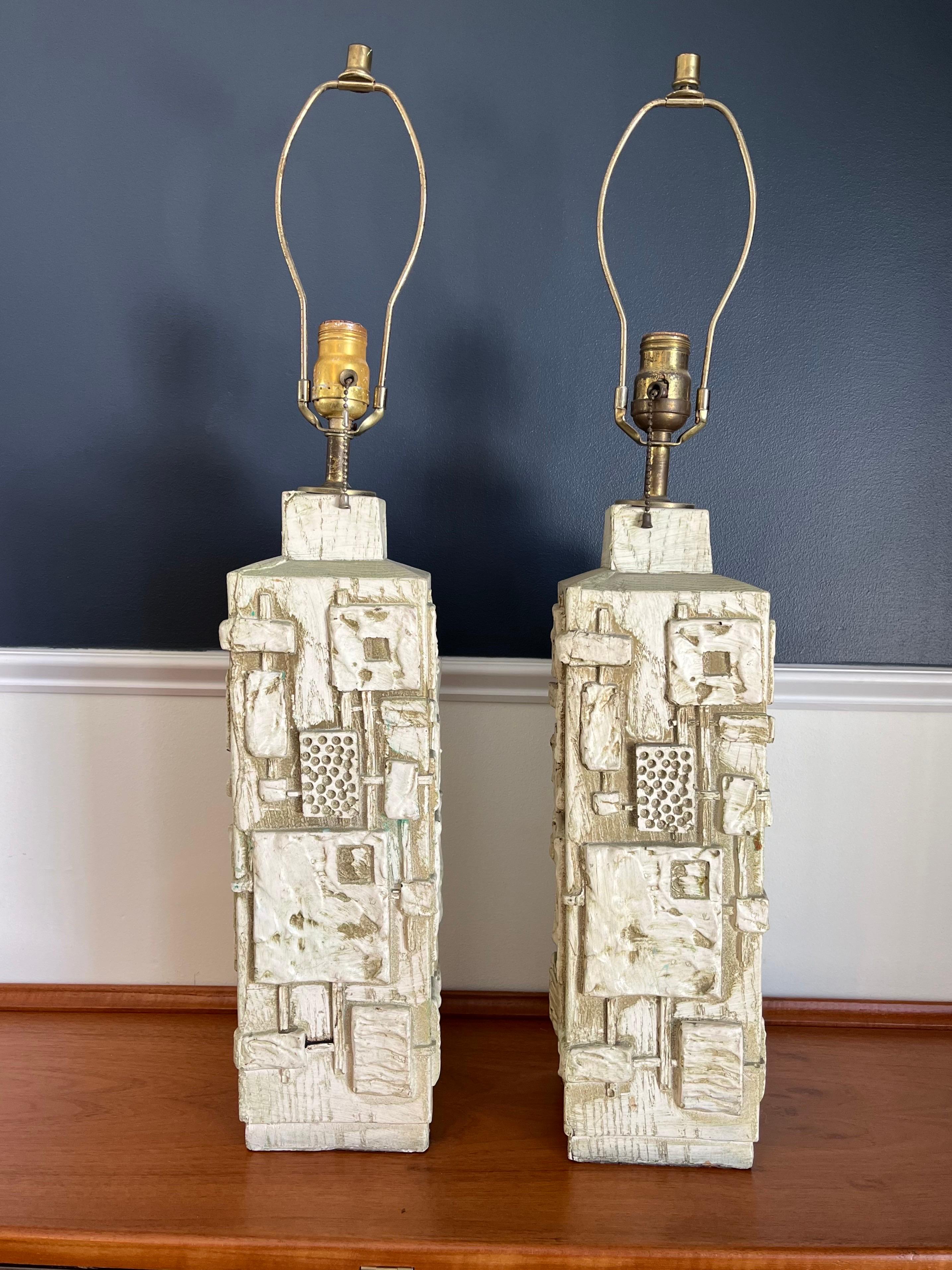 Mid Century C N Burman brutalist lamps. Fantastic brutal design with deep carved detail. Neutral color pallet with dramatic presence.