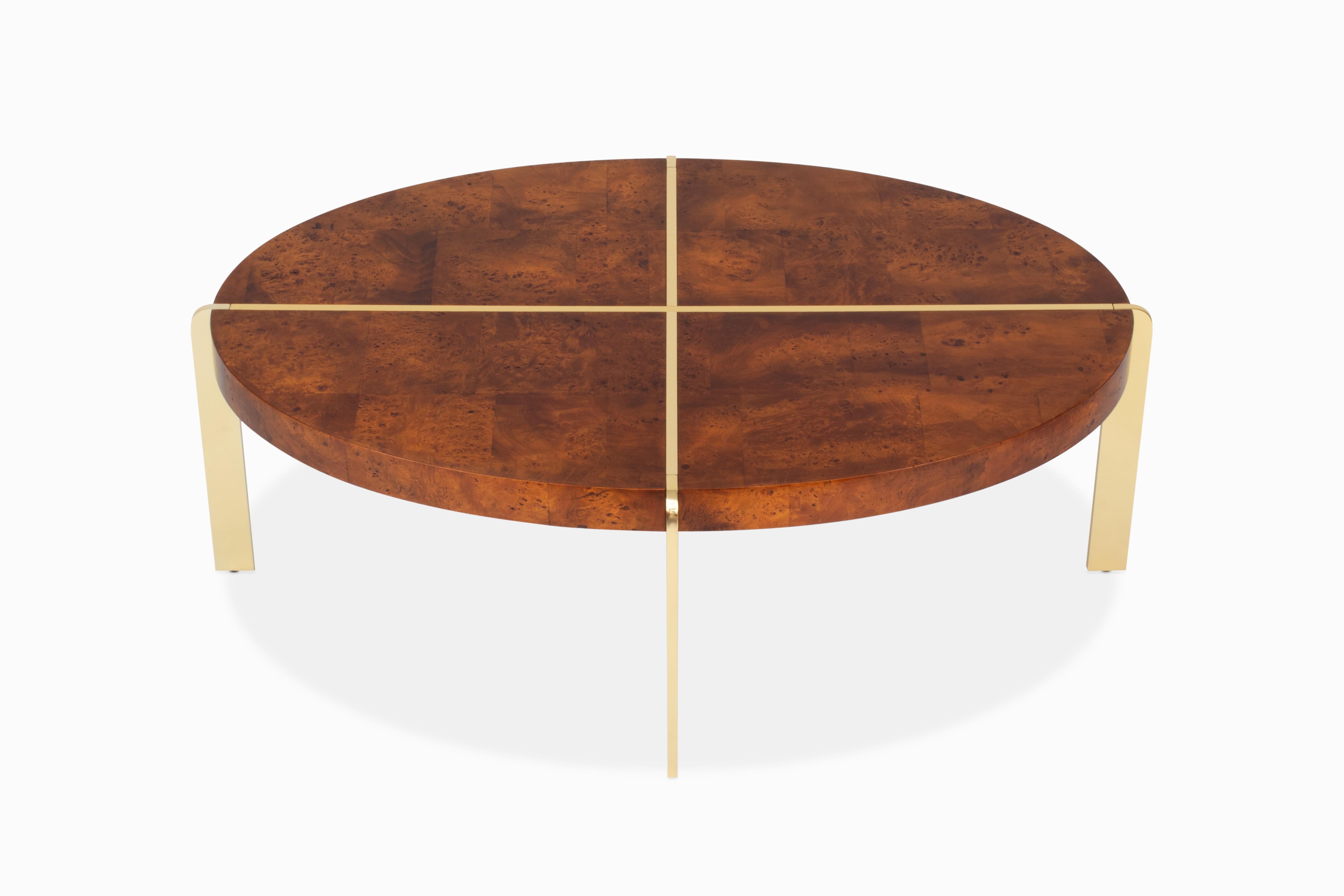 Here is a wonderful mid century oval coffee / cocktail table by Hekman in the style of Milo Baughman. It is comprised of patchwork olive burl veneer with solid brass elements. This table is a nice versatile size at 46