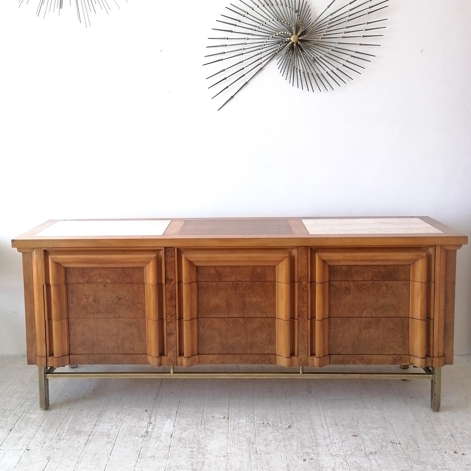 Rare midcentury sideboard with nine drawers by J.L. Metz Furniture, USA 1960s-1970s.
Carpathian burl elm drawer fronts, ends and central top panel; brass base; inset cream travertine panels in the top. The main cabinet is made from- I think- cherry