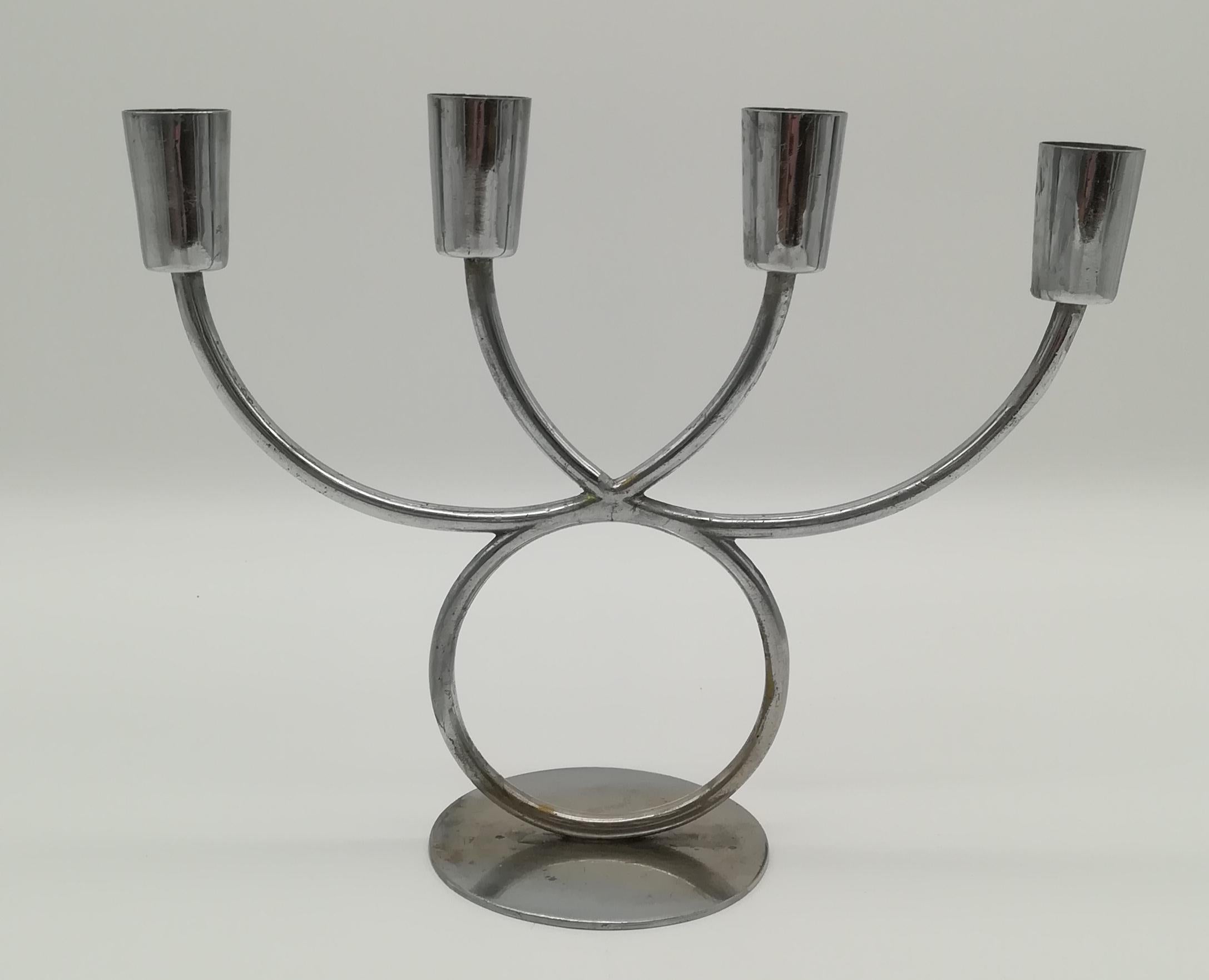 This thin, delicate nickle-plated brass candle holder dates from the late 1930's to the 1950's and thus elegantly shows the marriage of Mid-Century and Art-Deco forms. It is attributed to Karl Hagenauer, who was one of the most successful Austrian