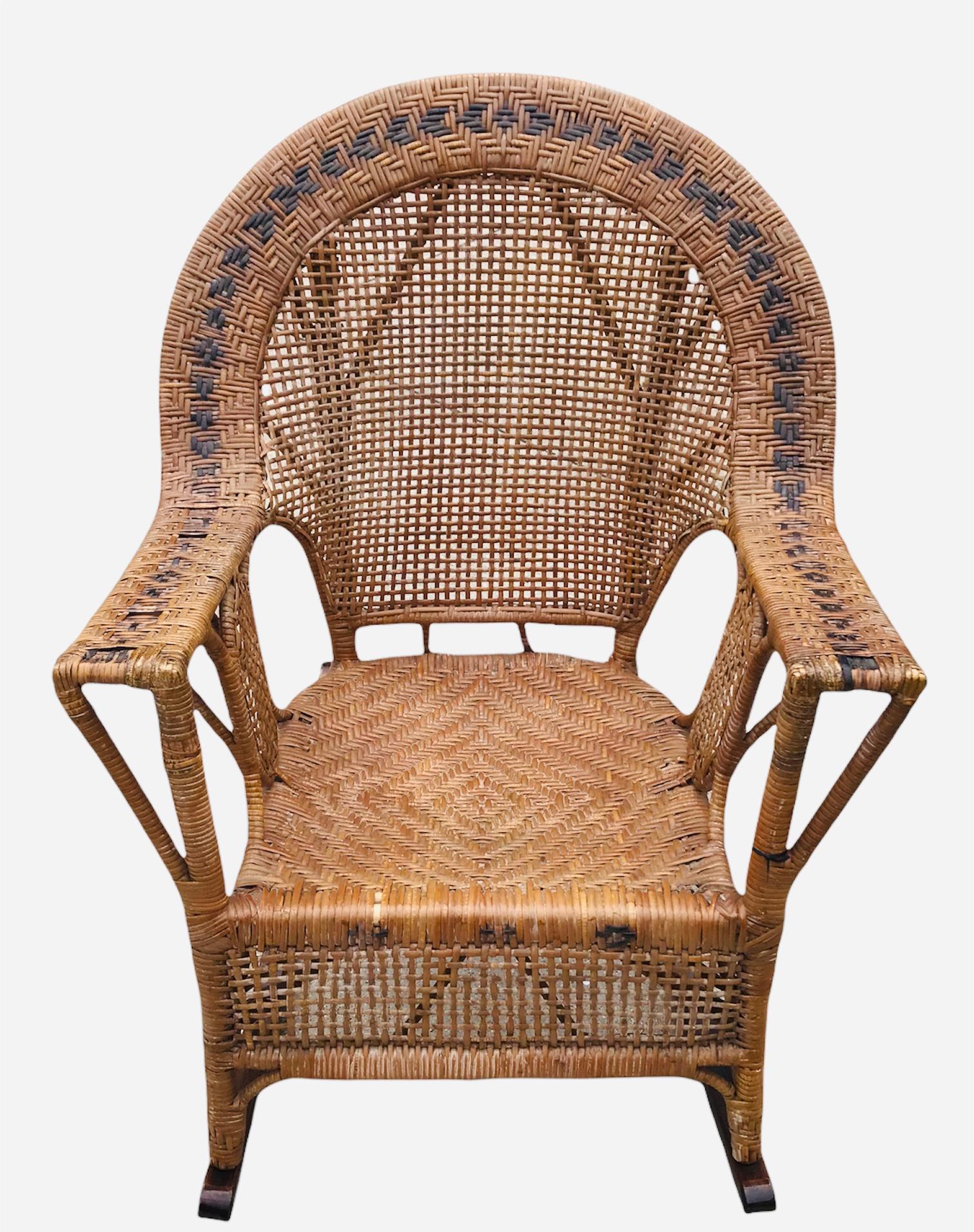 Such a spectacular woven cane Mid-Century Modern rocking chair. Minimalistic in design with unique character of the black herringbone-like design arched around the top back area of chair.