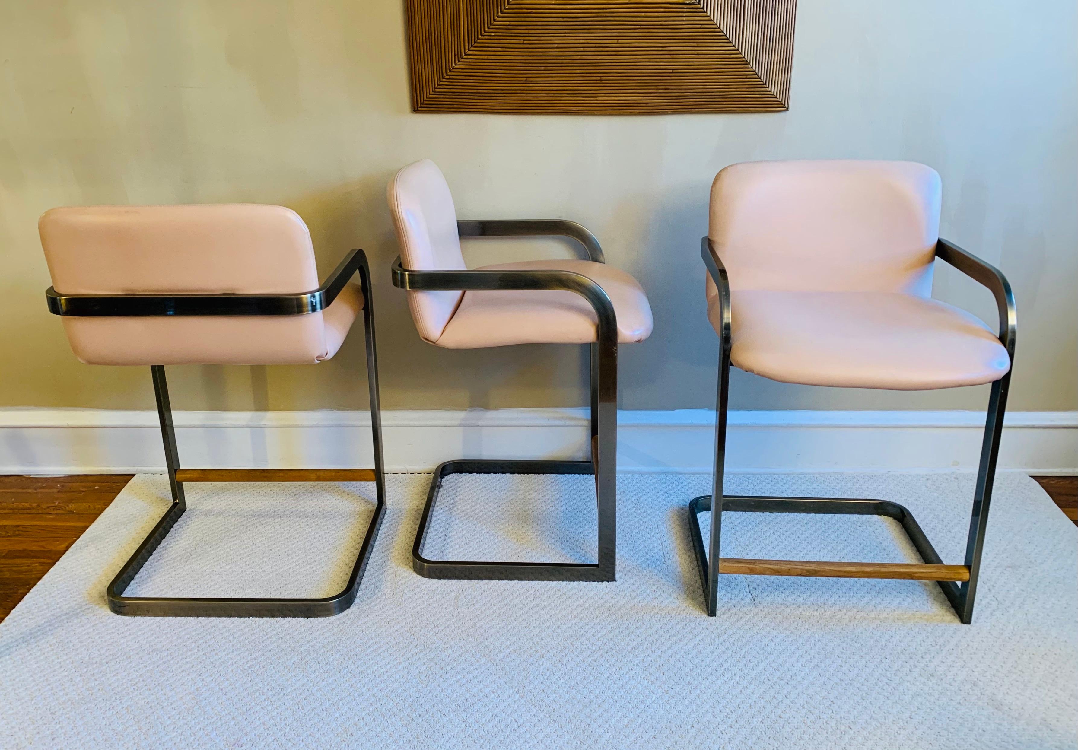 A wonderful trio of scarce cantilever stools that is often attributed to Milo Baughman, yet these retain the original tags from D.I.A. The word is still out as to if Milo was actually a designer under the DIA label. 

Due to the hue of the