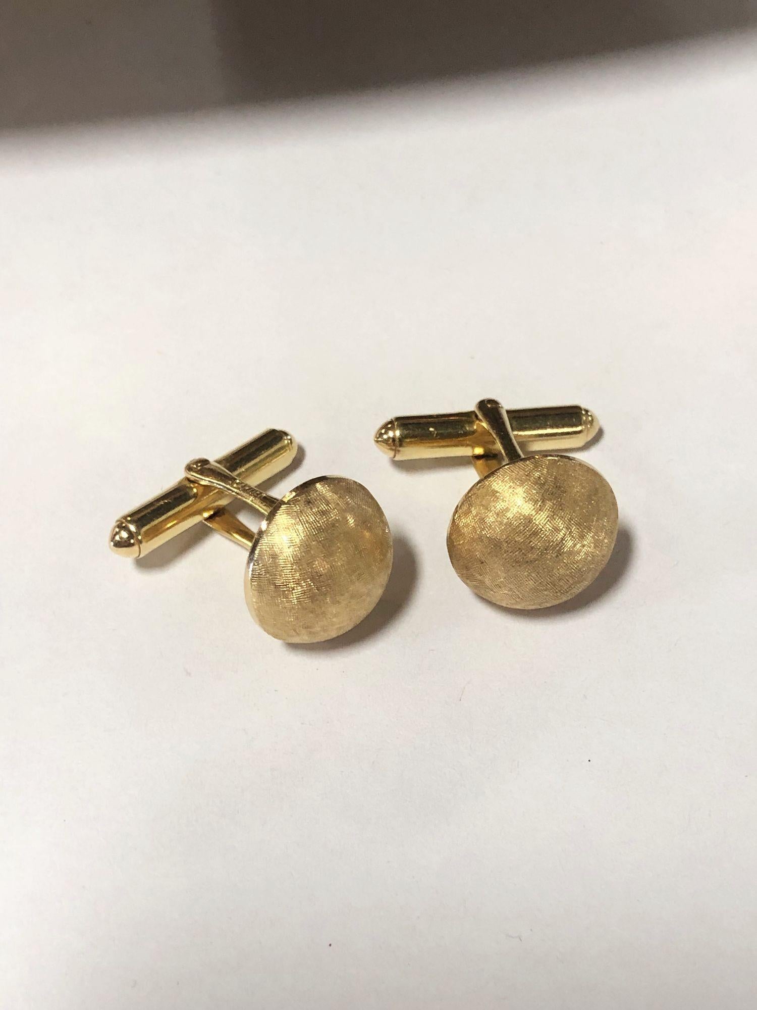 Exquisite and timeless estate jewelry, these vintage mid-century Cartier cufflinks exude opulence. Crafted in gleaming brushed gold, their classic mid-century design showcases Cartier's elegance and sophistication. A luxurious statement accessory,
