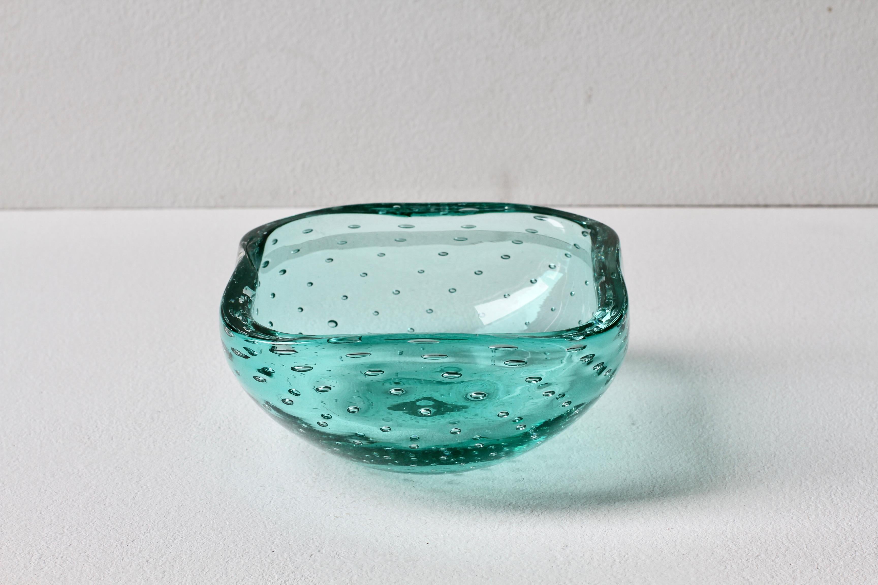 Beautiful Italian four sided bowl, dish or ashtray by Cenedese, but in the style of works by Carlo Scarpa for Venini. Made from stunning light aqua green Murano glass bullicante or 