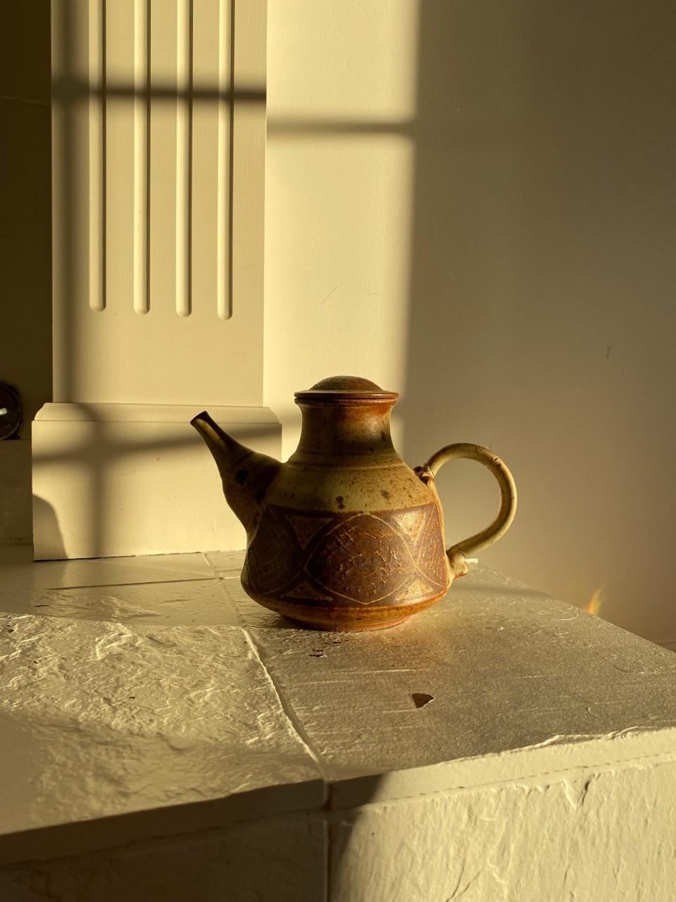 Great stoneware ceramic tea pot. Beautiful design with variety of techniques. This piece has cracks from restoration that do not deter of its style and beauty. Signed on the bottom (unknown). 1960s

East Coast, Organic Modern, Hollywood Regency,