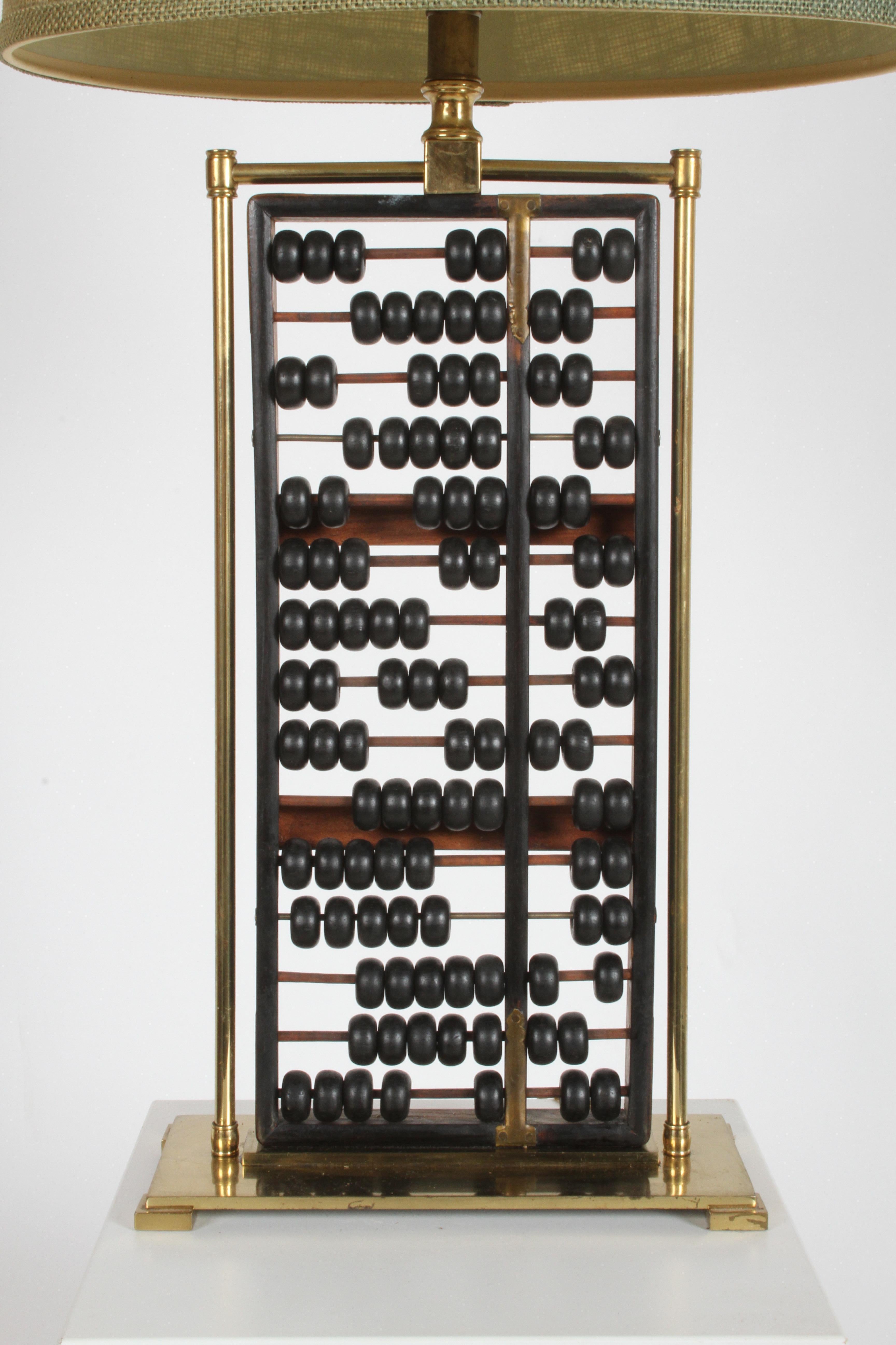 Mid-Century Chinese wood abacus lamp with brass frame, shown with original lamp shade and finial. Has white glass diffuser that holds shade. Newer lamp cord, minor wear to brass. Measurements shown below are with shade. Measurements without shade