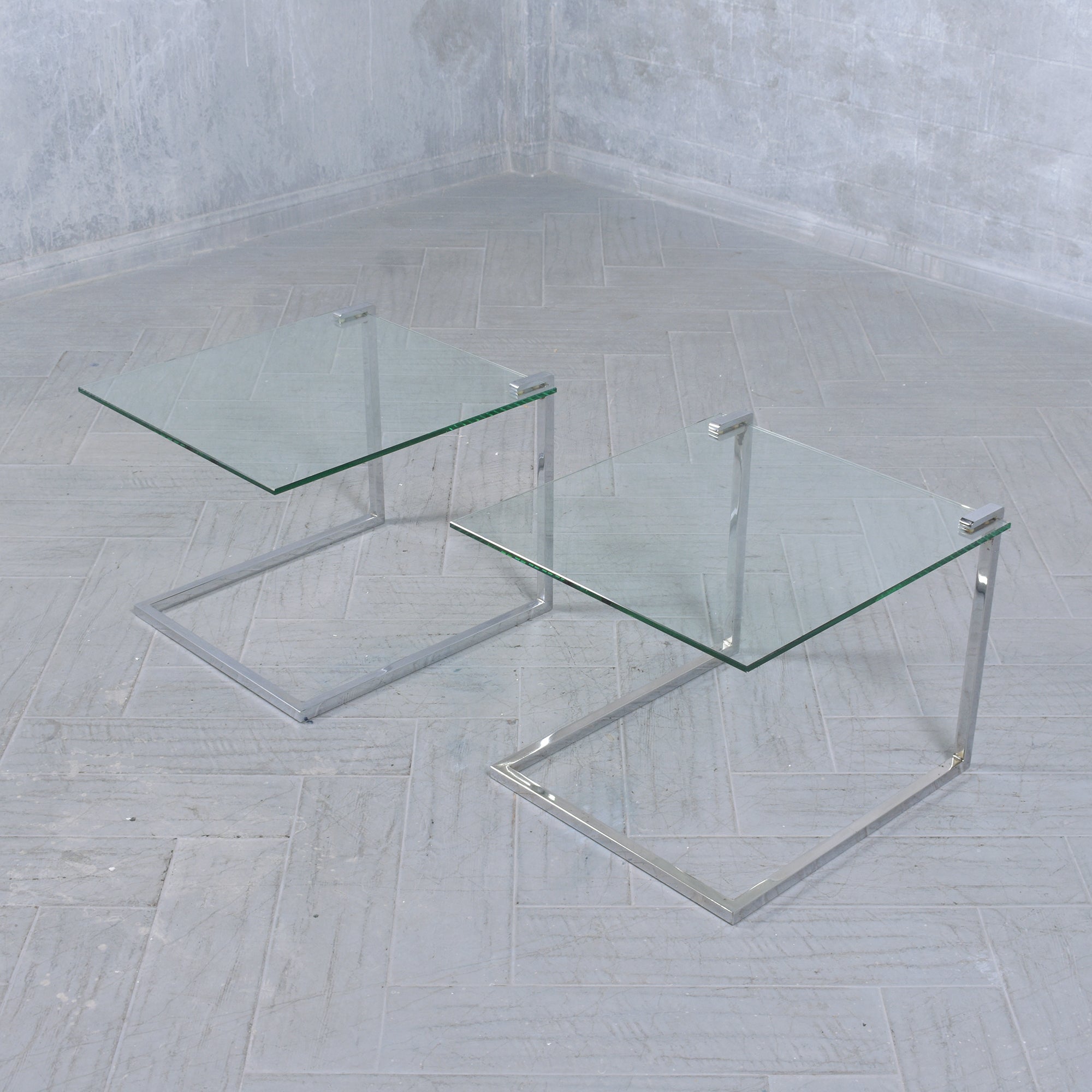 Experience the charm of mid-century design with our extraordinary pair of end tables, meticulously crafted out of steel. This vintage set showcases a unique 'C' design on the frame and features new 3/8 inch thick clear glass tops with flat polished
