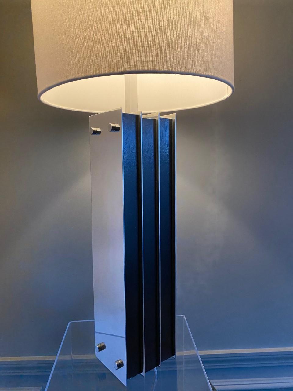 Beautiful and striking midcentury column table lamp by Laurel. This piece exudes modernism by its unique column like form. Chrome metal plates envelop the sides as ebonized wood is displayed with linear chrome metal details that make it sculptural.