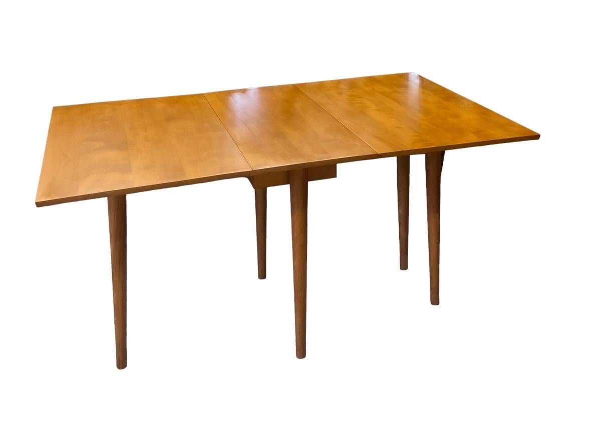 Vintage midcentury Conant Ball Leslie Diamond Solid wood Drop leaf Maple Dining Table.

Dimensions. 65 1/2 W ( Extended) ; 42 D ; 30 H

Each Leaf Measures 24 1/2 W.