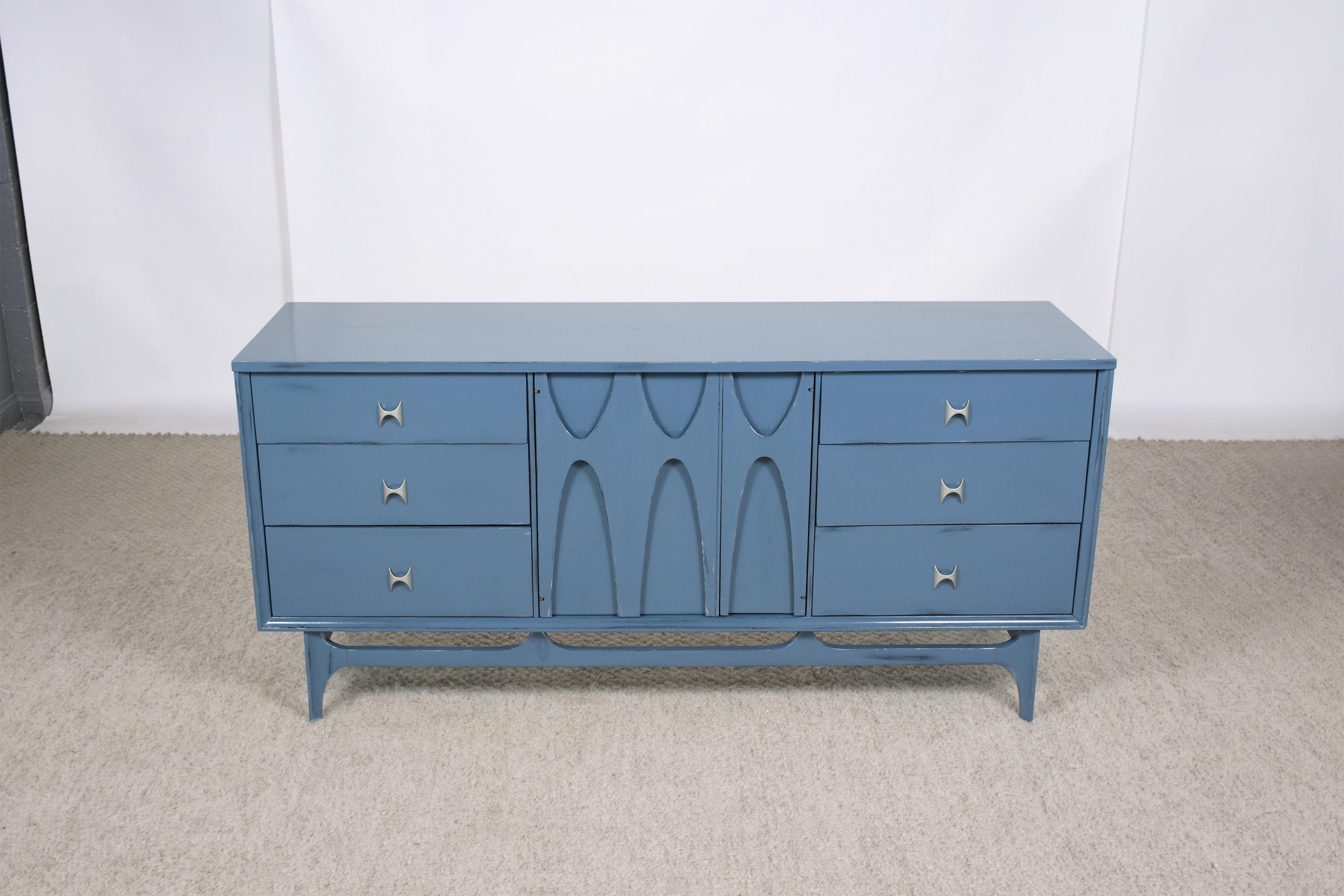 Step back into the stylish 1960s with our beautifully restored Broyhill Brasilia credenza, a hallmark of mid-century modern design. This vintage piece has been hand-crafted with precision and care, then given new life by our team of expert craftsmen
