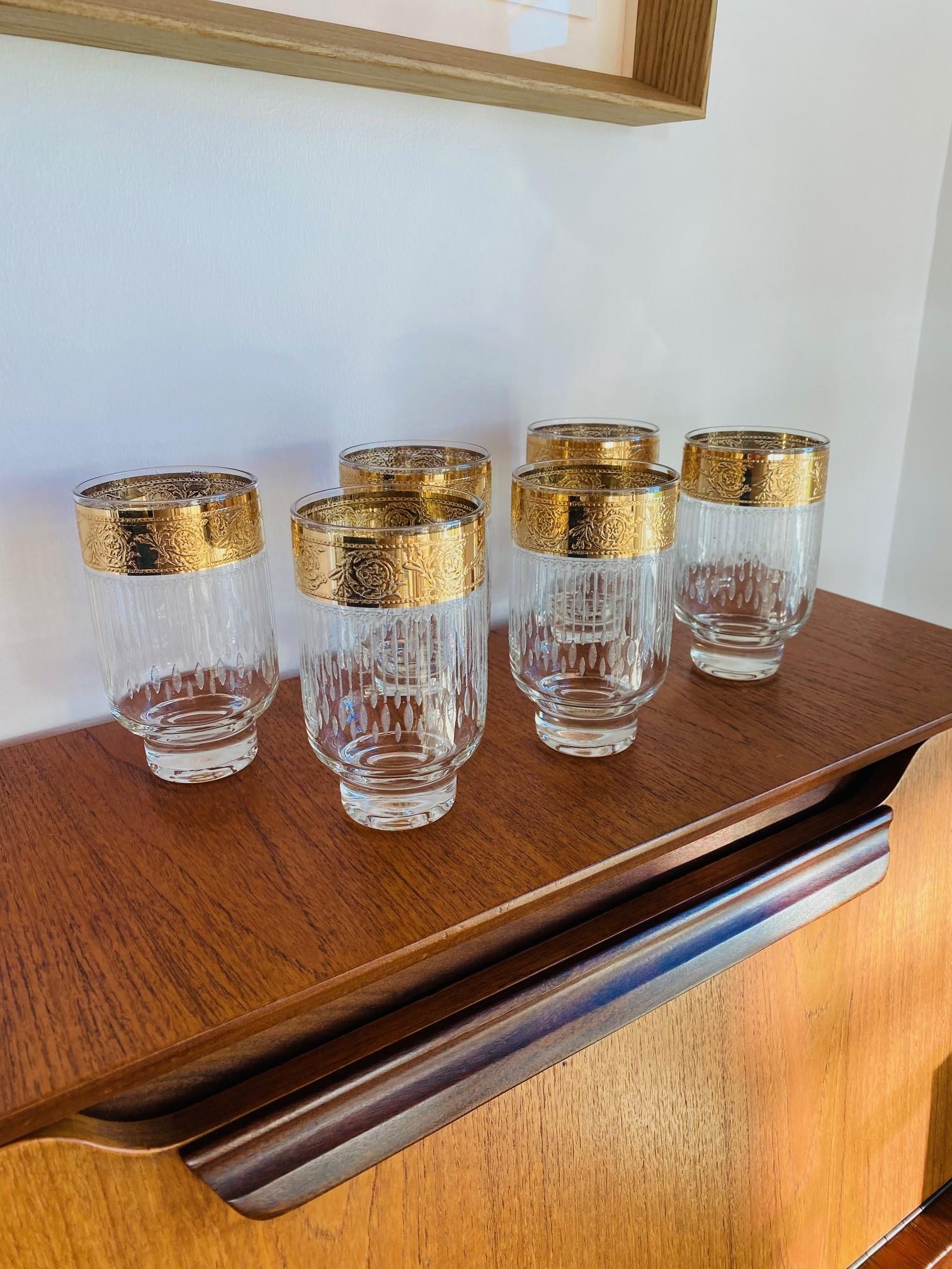 Unique and rare. Beautiful set of 6 vintage, mid-century hi-ball glasses by Culver.  This design by Culver relegates you to a decade of glamour and beauty.  The design of this glass is sculptural.  Balanced over a glass base, the crystal flourishes