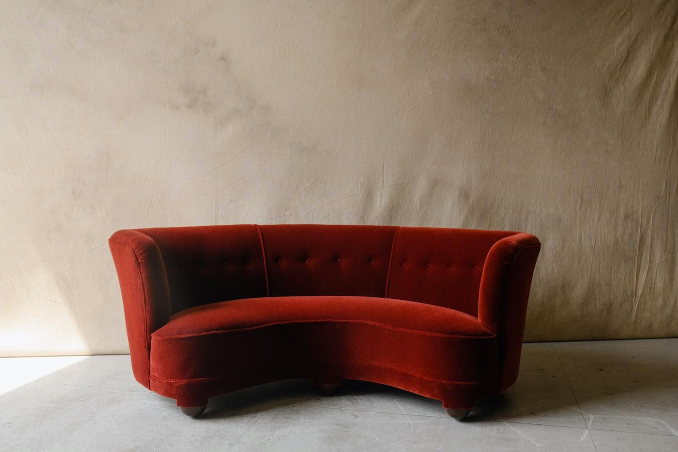 Vintage Mid Century curved sofa in mohair velvet from Denmark, Circa 1950. Superb Danish cabinetmaker sofa upholstered in a deep red velvet mohair fabric. Excellent condition with very light use. 

We don't have the time to write an extensive