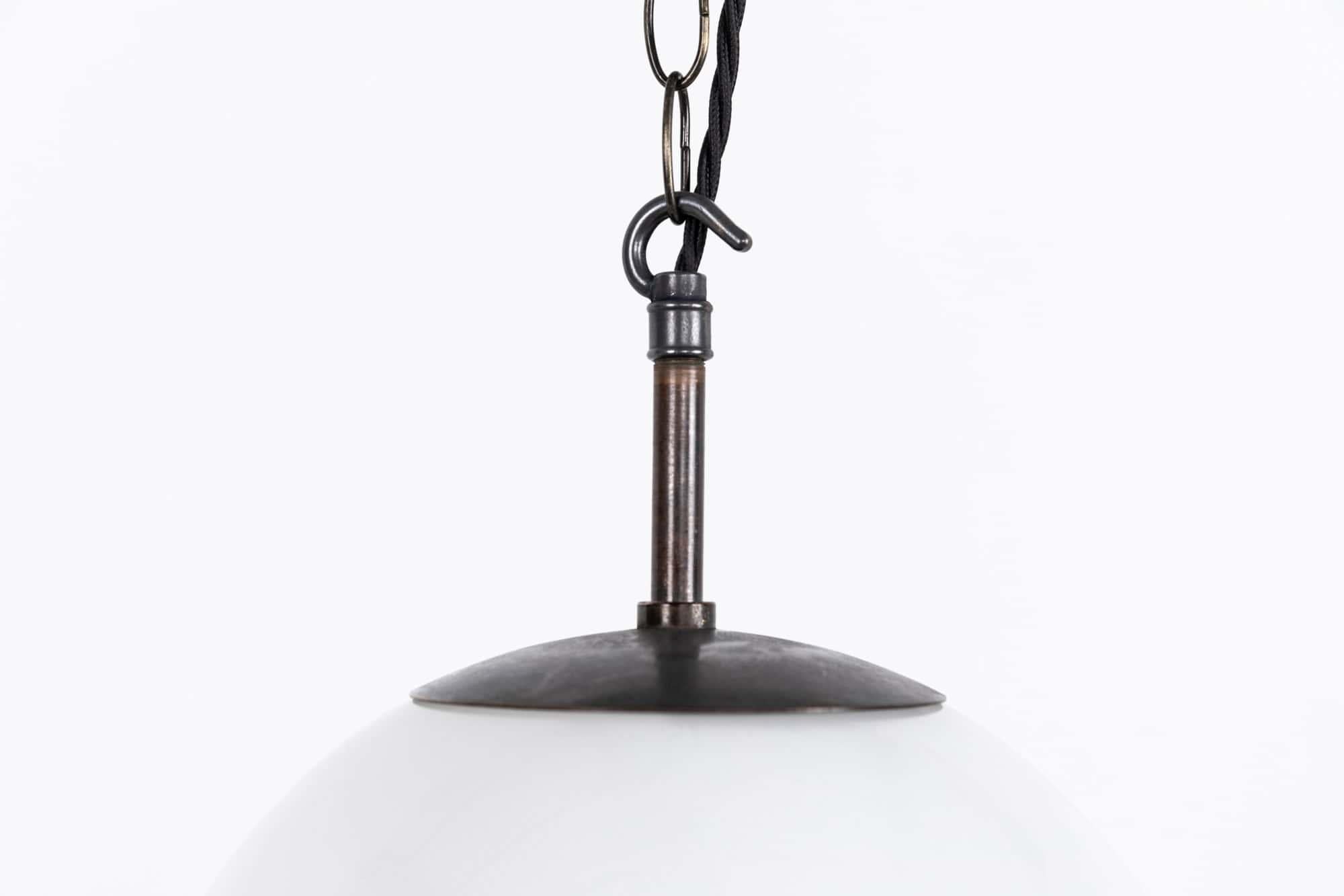 

An elegant white opaline glass pendant made in former Czechoslovakia. c.1950

Moulded dome shaped opaline glass shade with a vortex-like underside and copper monks cap gallery.

Rewired with 1m of black twisted flex.
