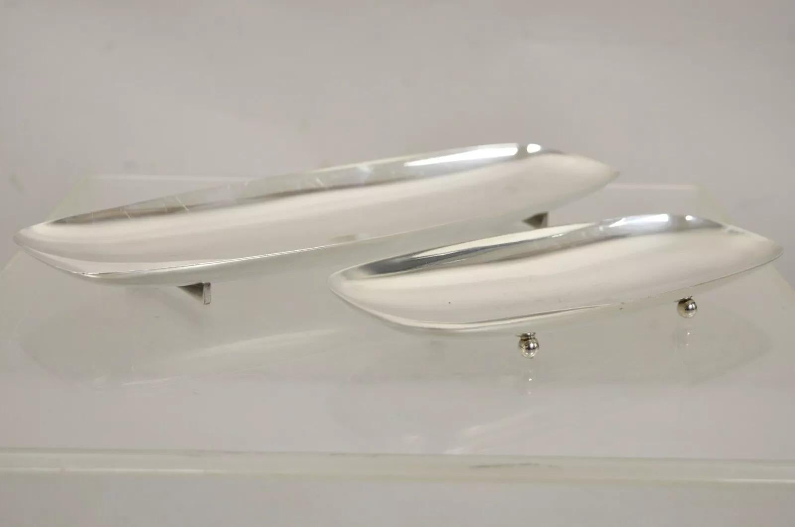 Vintage Mid Century Danish Modern Narrow Silver Plated Footed Dish Tray Set - 2 Pcs. One with ball form feet and the other with sculpted double pedestal feet. Circa Mid 20th Century. Measurements: Larger: 1