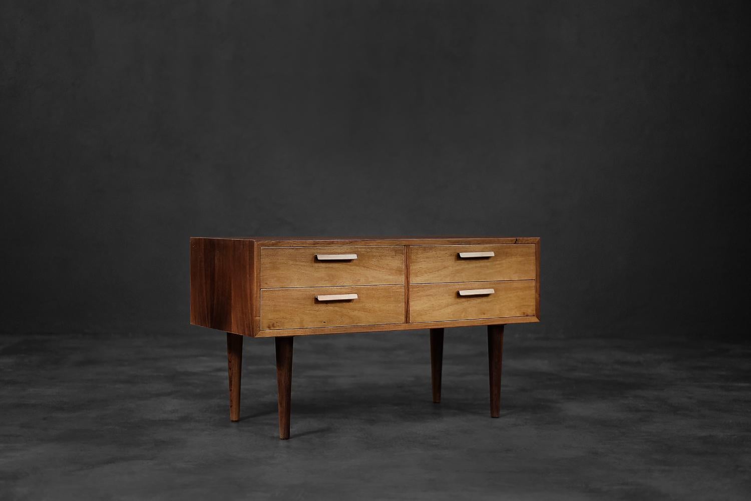 This elegant chest of drawers was designed during the 1960s by Kai Kristiansen for the Danish manufactory Feldballes Møbelfabrik. It is made of high-quality, noble rosewood with rich graining. The chest of drawers has four drawers, and the fronts