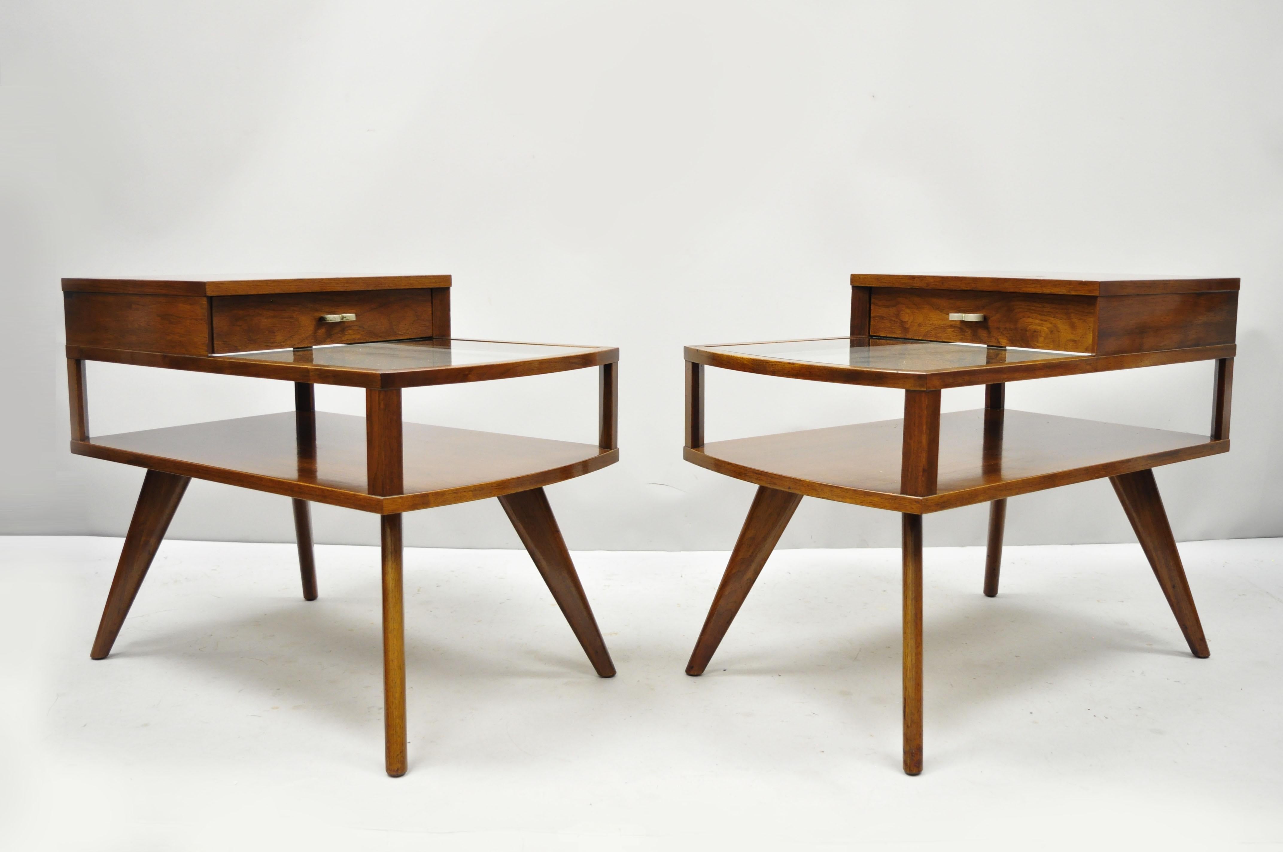 Vintage midcentury Danish modern walnut and glass two-tier step end tables. Item features 