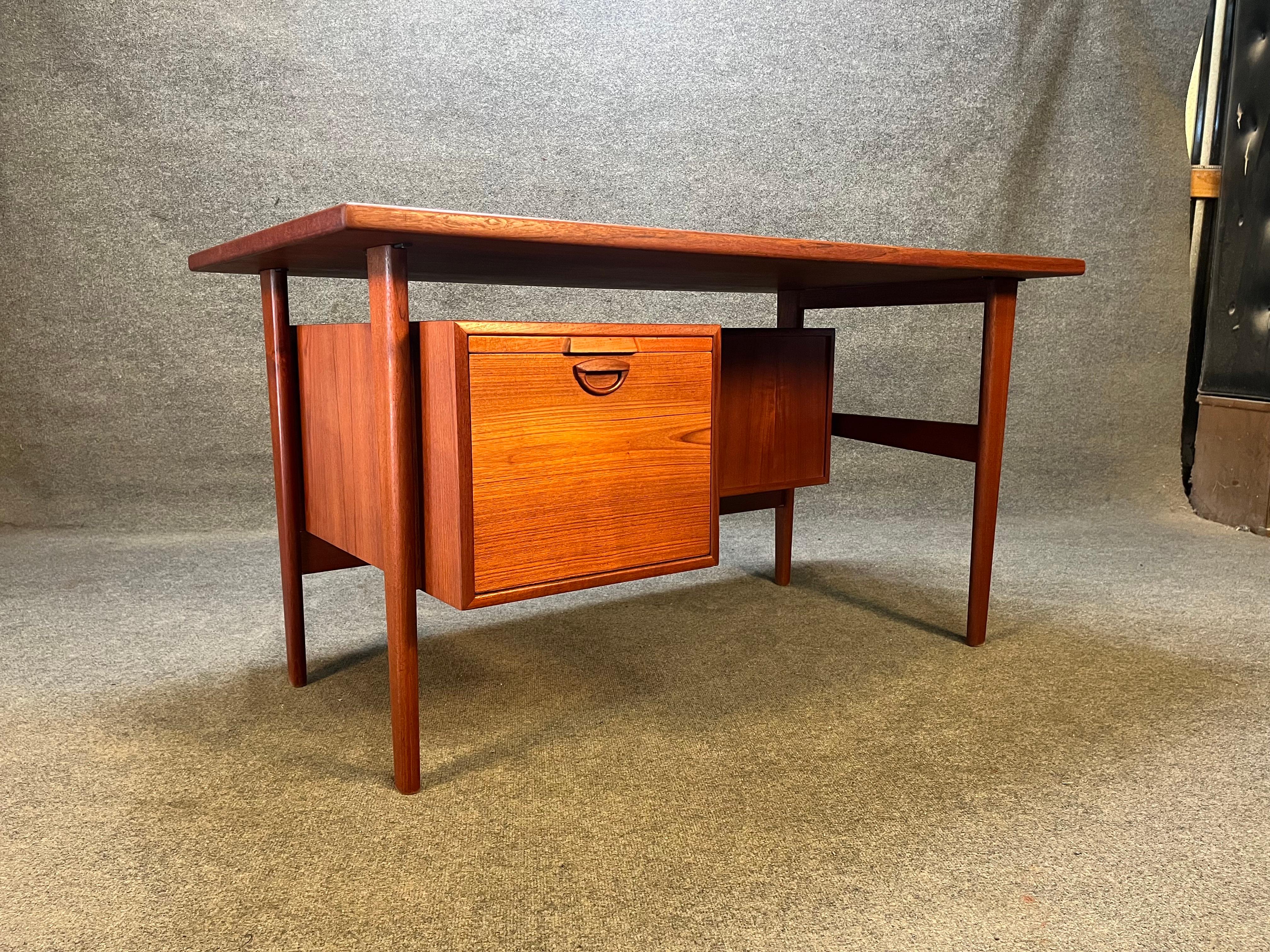 Here is an extremely rare desk by Kai Kristiansen for FM Mobler Denmark. This is a smaller version of his famous FM60 desk. Desk features 1 large drawer on the left side with a pullout writing table. Desk also features a finished back with two open