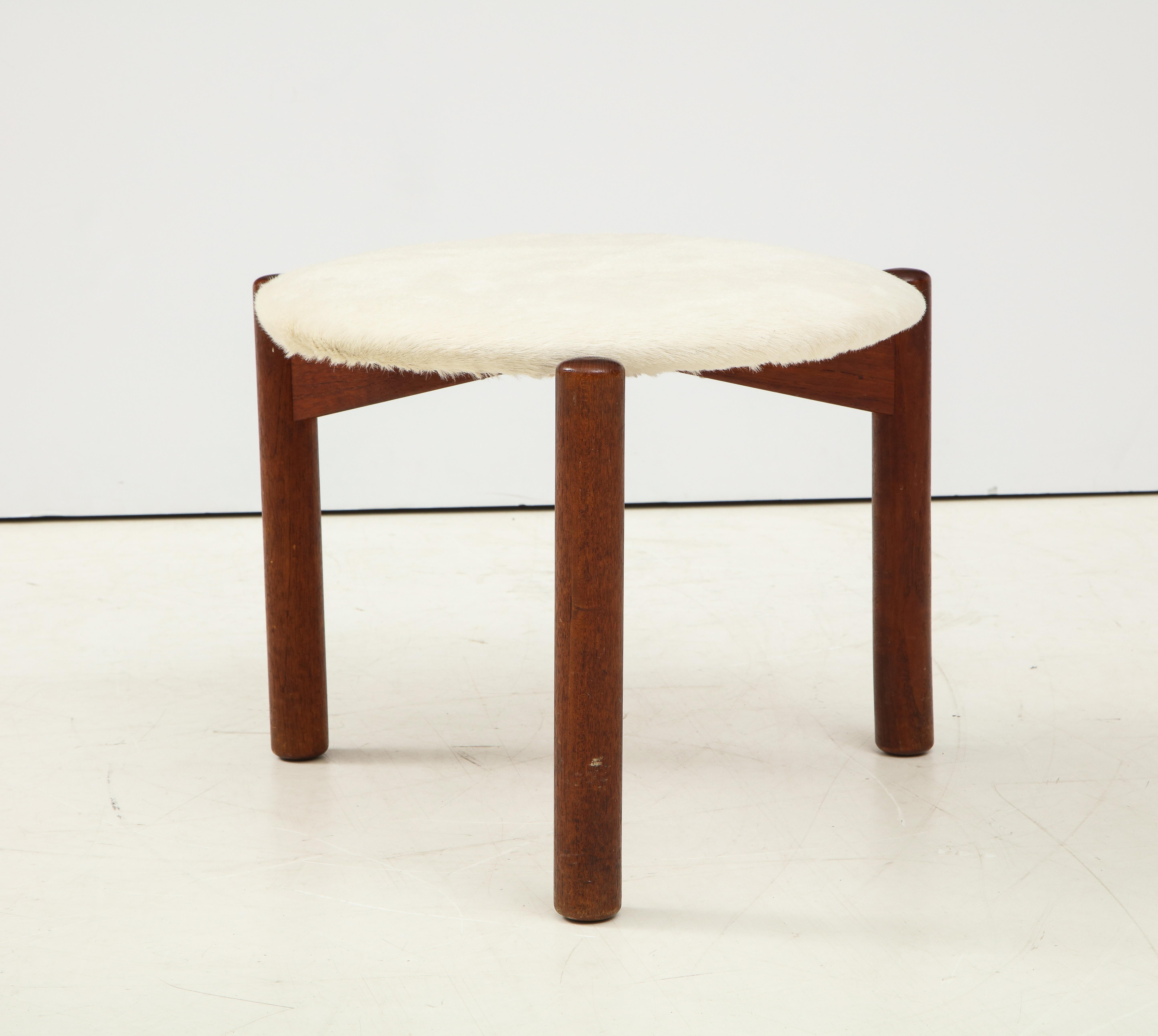 Vintage Mid-Century Tripod Stool with Cow Hair. 

This chic stool consists of a sleek tripod base, tubular hardwood legs, and a sizable round seat upholstered a plush off-white cow hair. 

The frame of the stool has been lightly refinished and