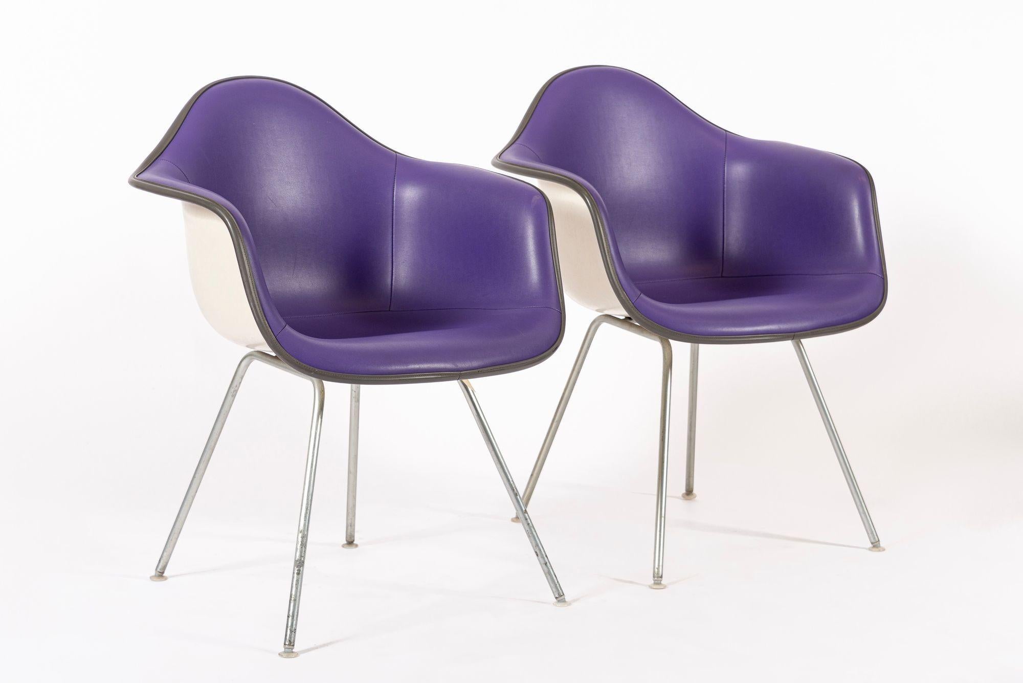 These vintage mid century modern purple DAX bucket lounge chairs designed by Charles and Ray Eames for Herman Miller were produced between 1965-1978. The iconic DAX chair - Dining (D) Arm Chair (A) on X Base (X) - was designed by the Eameses for