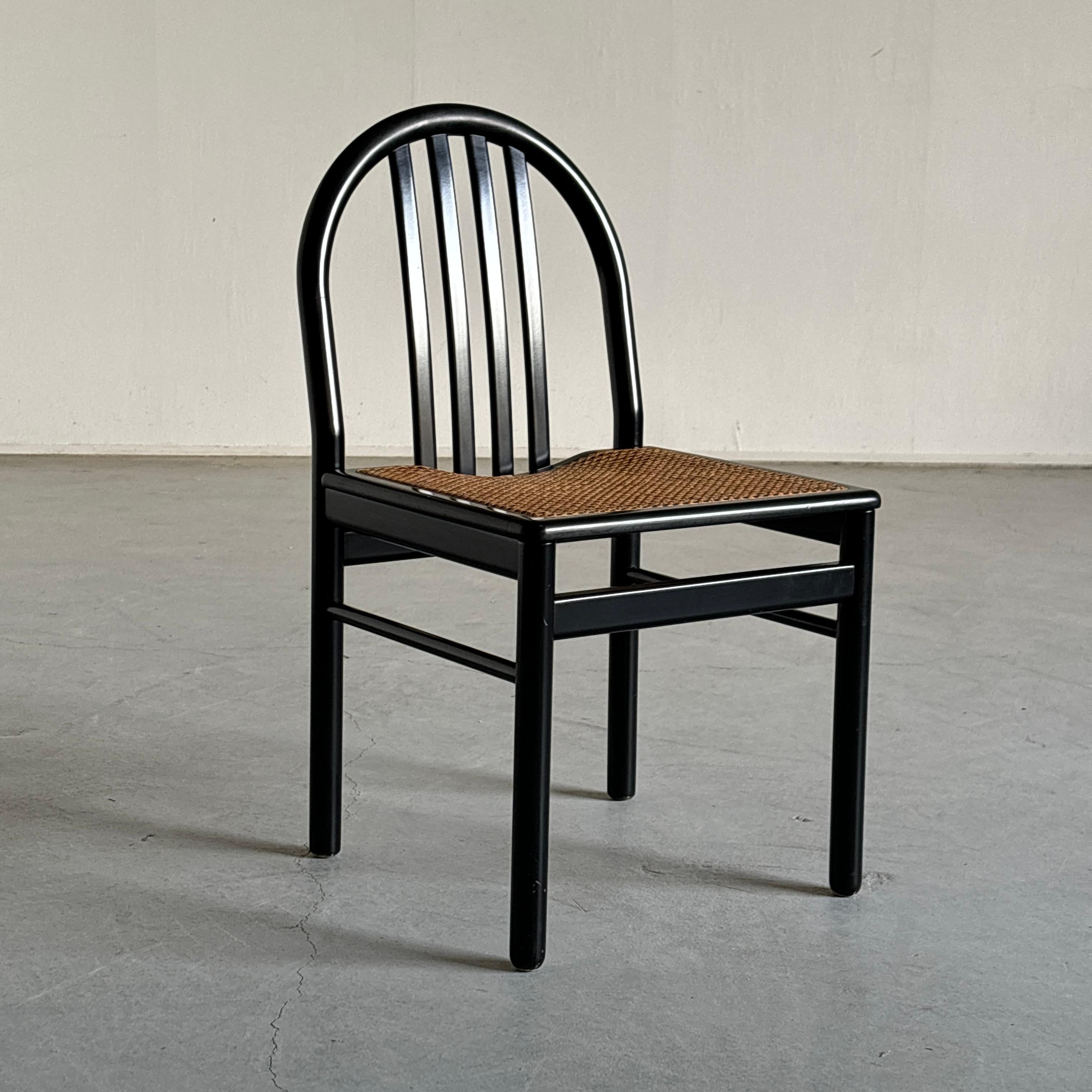 Vintage mid-century modern dining chair crafted from black acquered bentwood with caned seats, reminiscent of designs by Annig Sarian.
Produced in Italy during the 1980s, this chair offers a blend of natural materials and timeless design.

Chair is