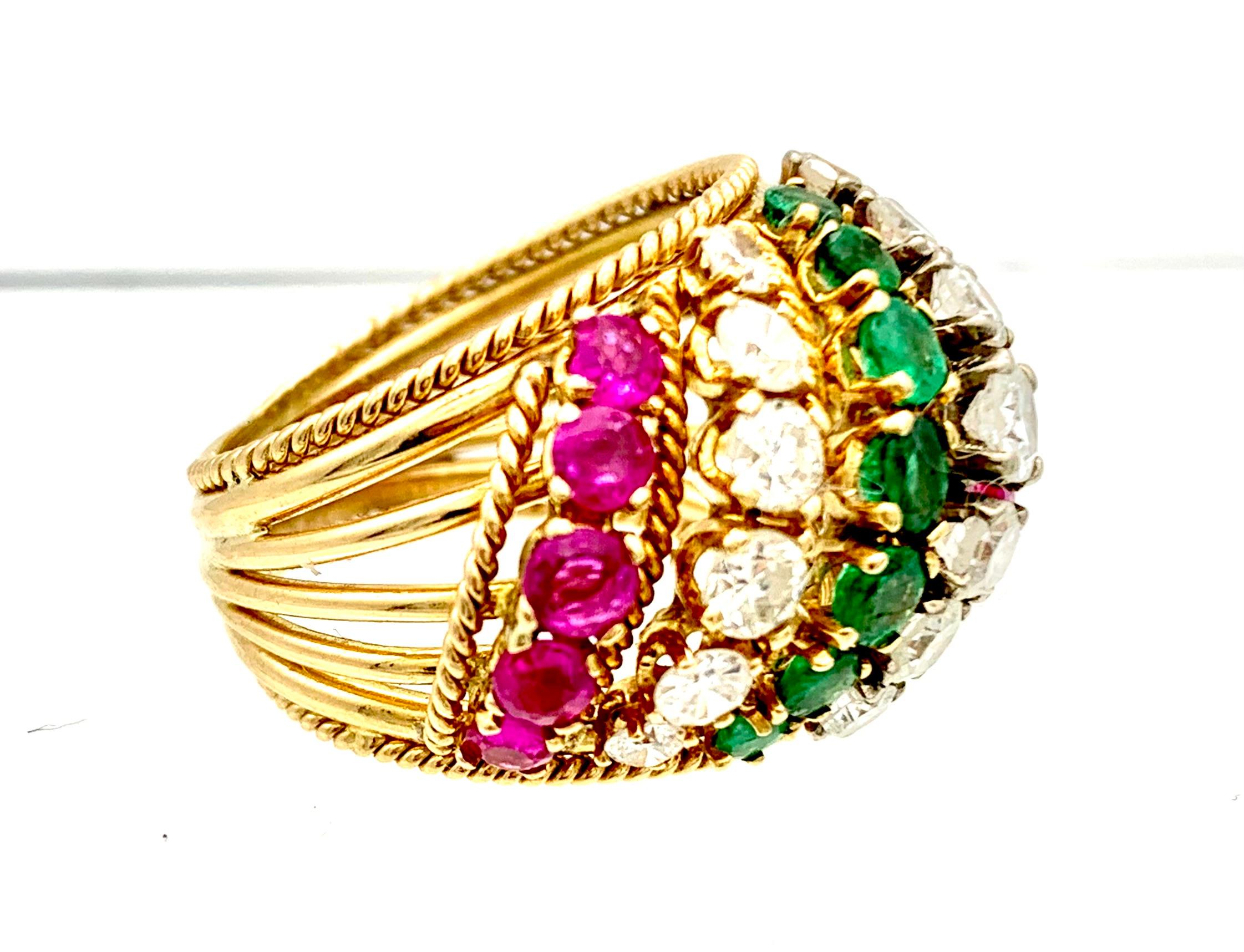 This elegant pinkie cocktail ring has been made out of 14 karat gold and is deorated with diagonal stripes set with emeralds, rries and diamonds.