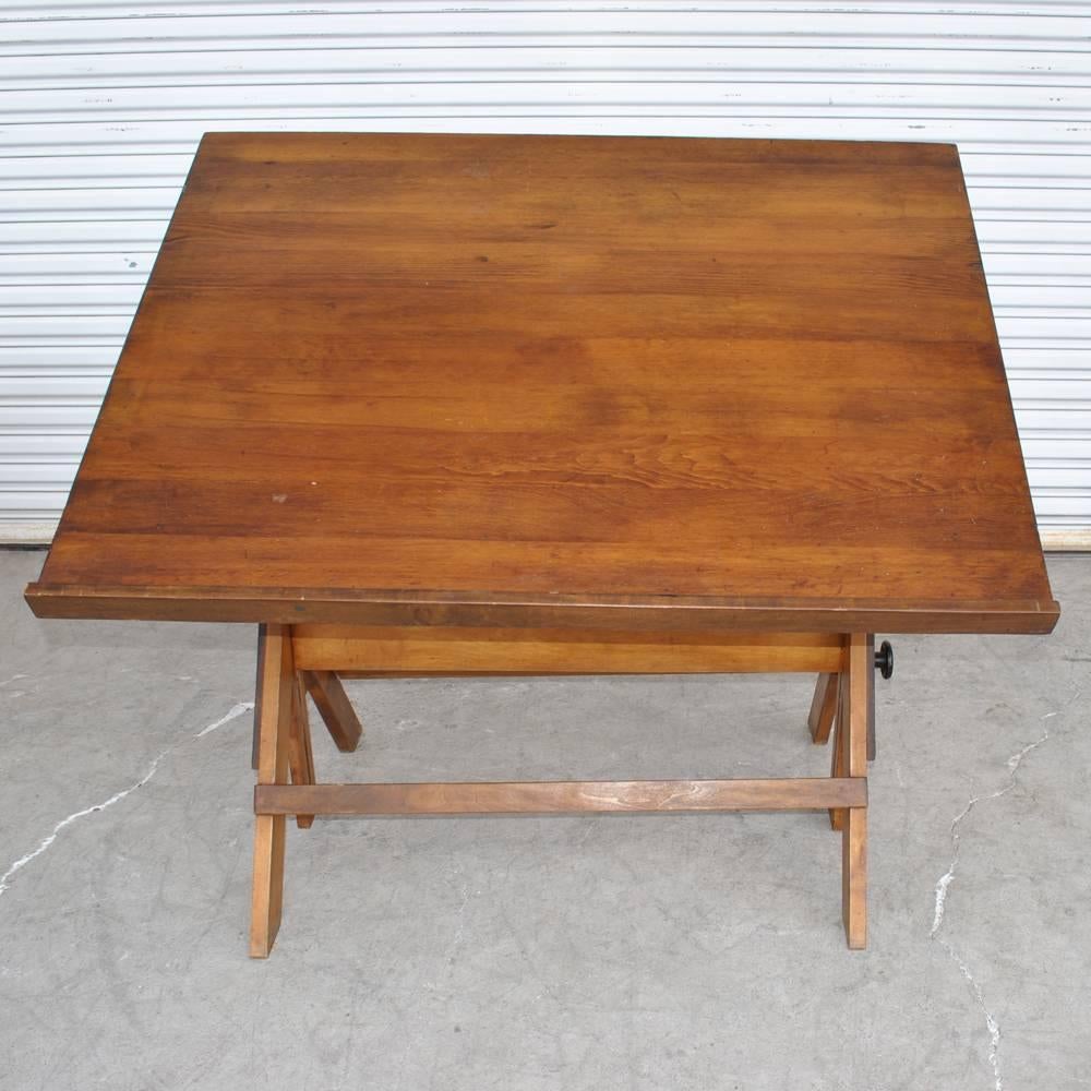 Vintage drafting table 
 
Midcentury drafting table with cast iron height adjusting mechanism.
Height adjusts: 32