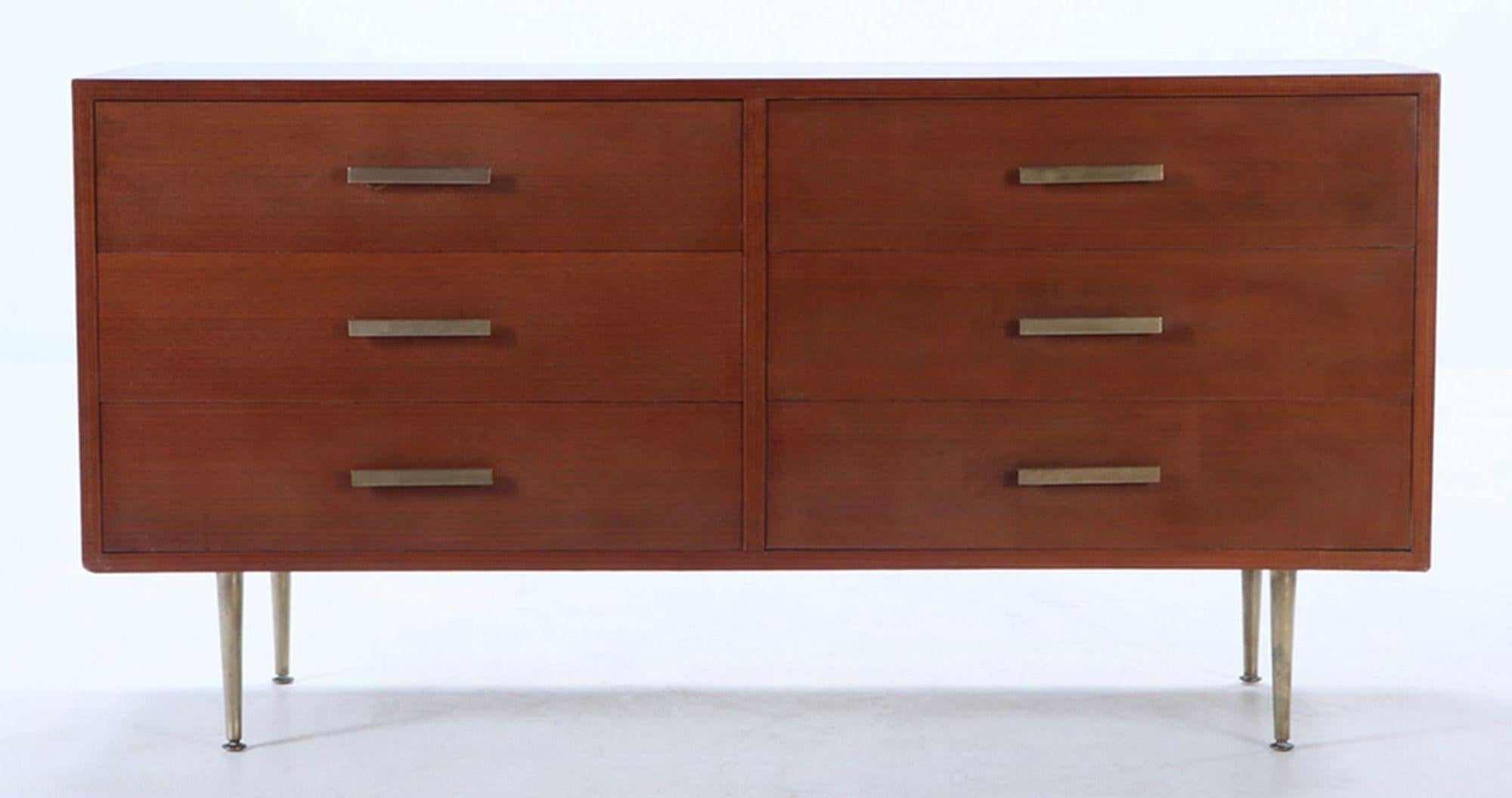 Vintage Mid-Century dresser made with rich wood showcasing the natural grain and warm tones that define the Mid-Century style, and also includes bronze legs and handles. The piece includes six spacious drawers. Elevating this piece are its