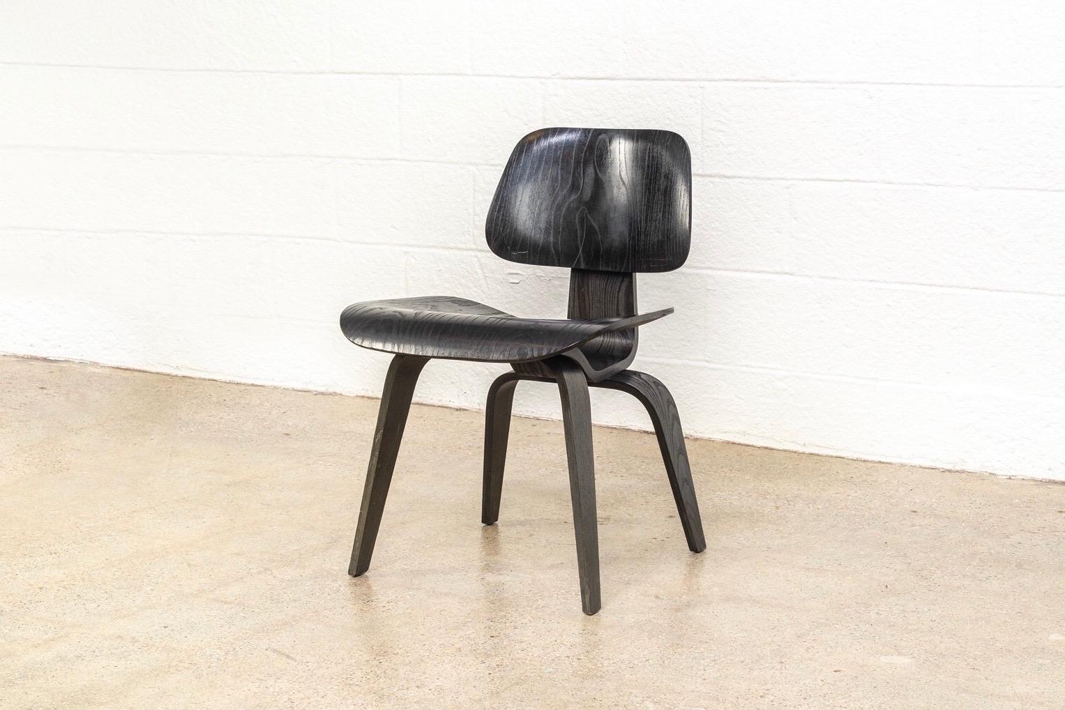 This original vintage Charles and Ray Eames for Herman Miller DCW dining chair is expertly crafted from ash molded plywood with black aniline finish. Designed in the 1940s and named Time magazine’s “Best Design of the 20th Century”, the iconic DCW