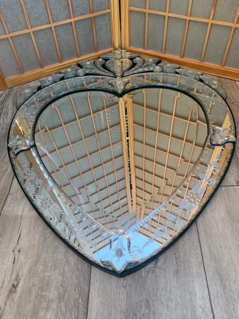 Vintage Mid Century Etched Venetian Glass Heart Mirror

Beautiful, vintage, mid-century Venetian glass wall mirror in the shape of a heart with etched glass and black wood back.

A fabulously Italian vintage Venetian glass mirror.

Circa