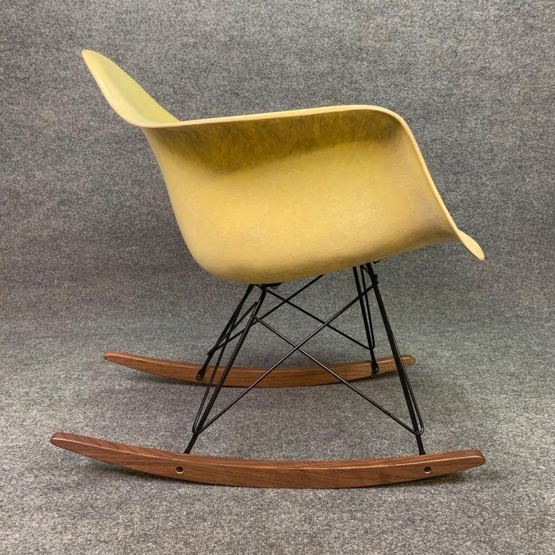 Here is a classic American made fiberglass rocking chair designed by Charles Eames.
This early 1950s shell, with its pale yellow color and vibrant fiber details, has been cleaned up and received a new gel coat finish. All the shock mounts are firms