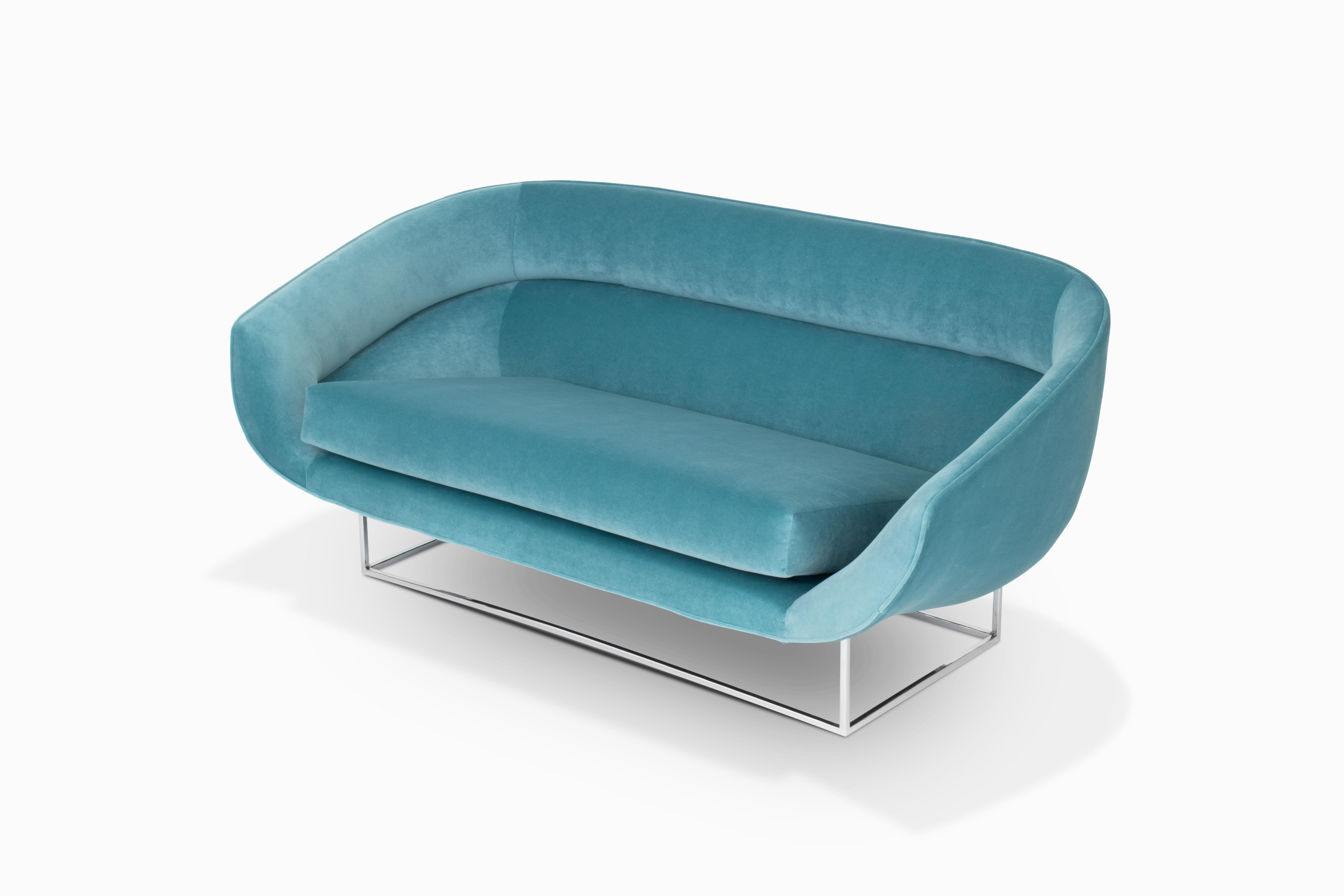 Here is a remarkably beautiful floating sofa by Milo Baughman / Thayer Coggin. The curvaceous seating pod has been reupholstered in a luxurious turquoise blue velvet. And it sits upon a newly chromed metal base. This is an uncommon design by Milo
