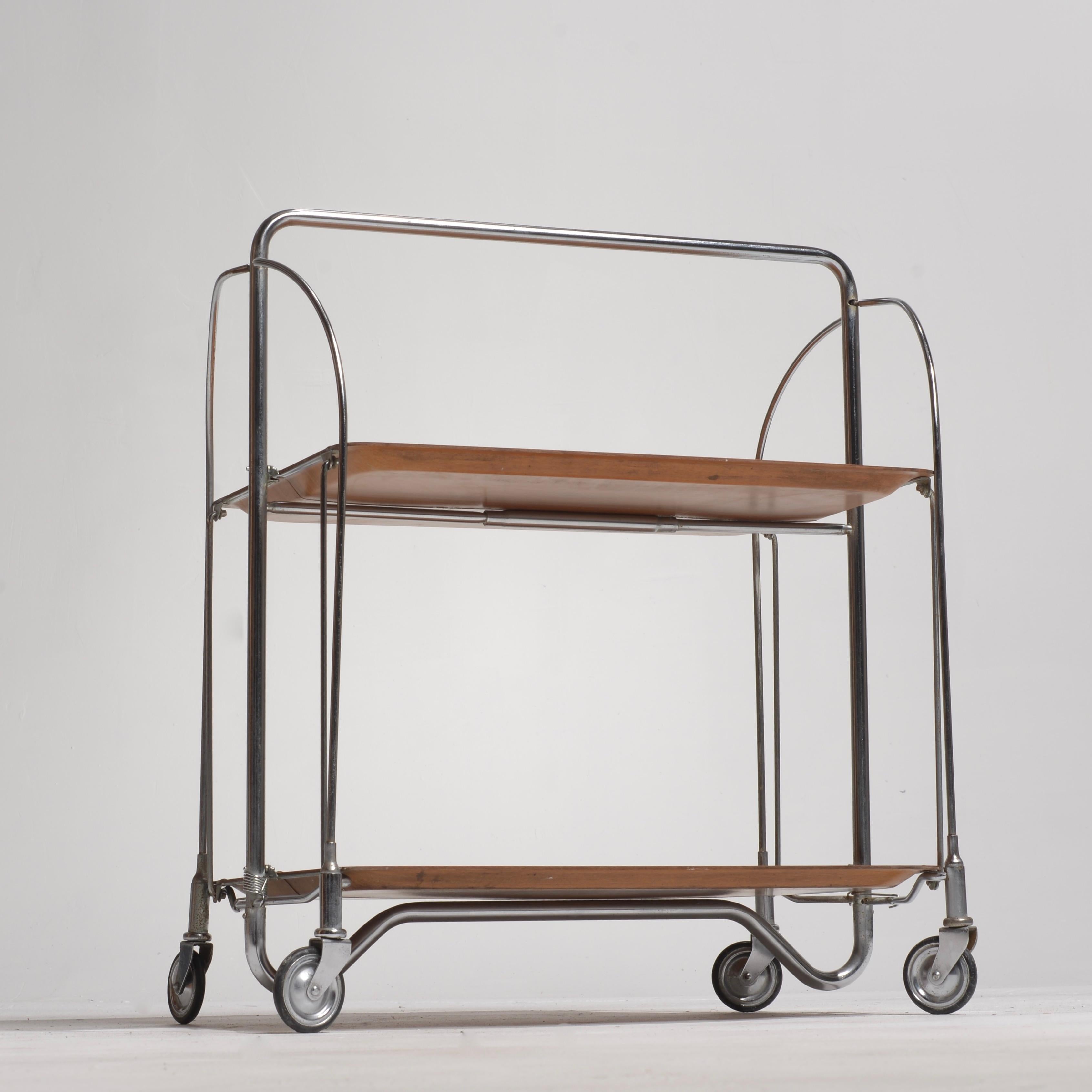 Vintage west German mid-century foldable serving trolley. Bakelite tops with metal frame. Very good condition. 1950-1975