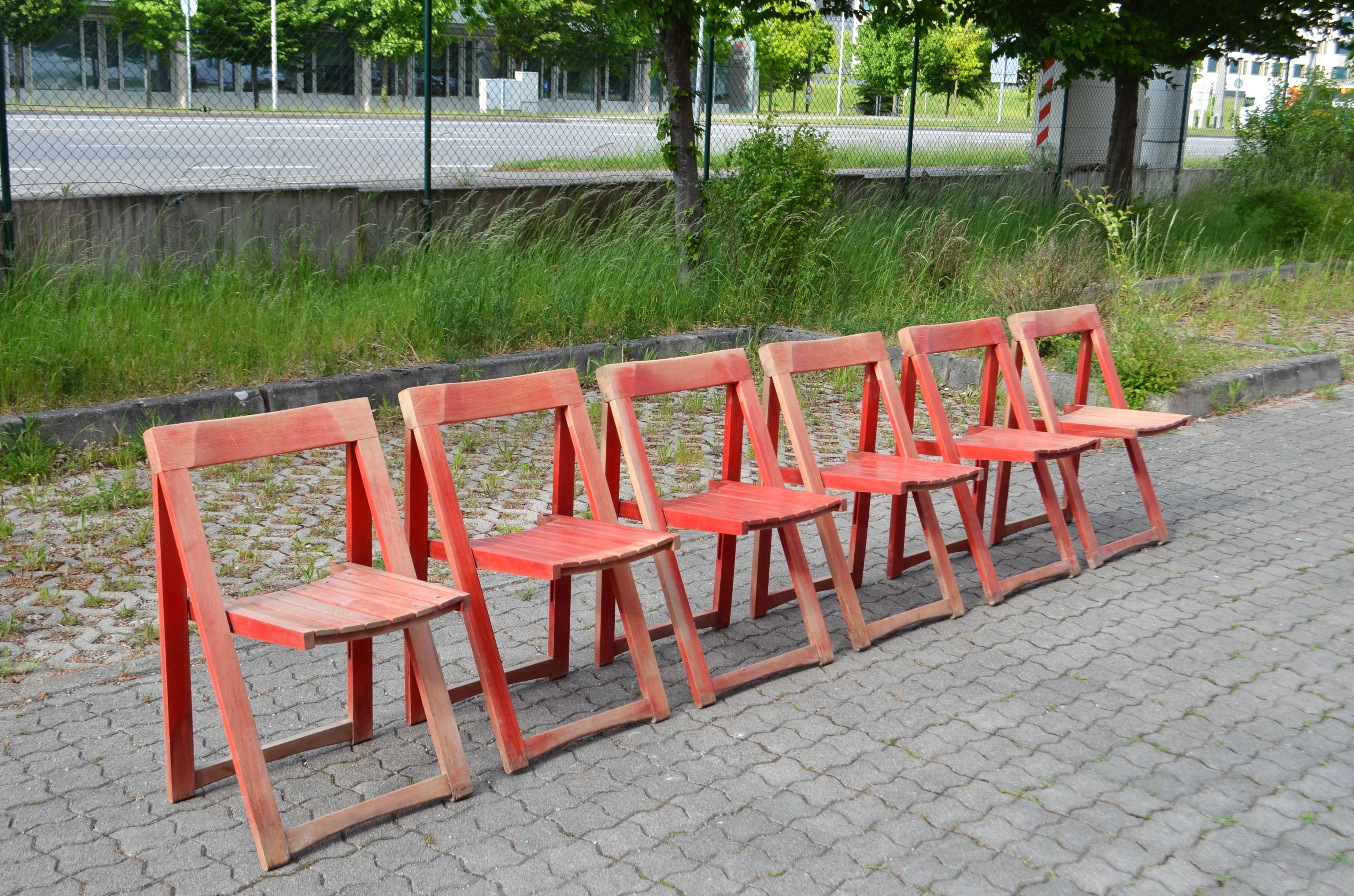 This Mid-Century folding chair was manufactured in Yugoslavia. It is made of solid beech wood and features a beautiful patina, where the original red color has now faded. Some signs of wear and patina are present. Comfortable seating. 

Price is for