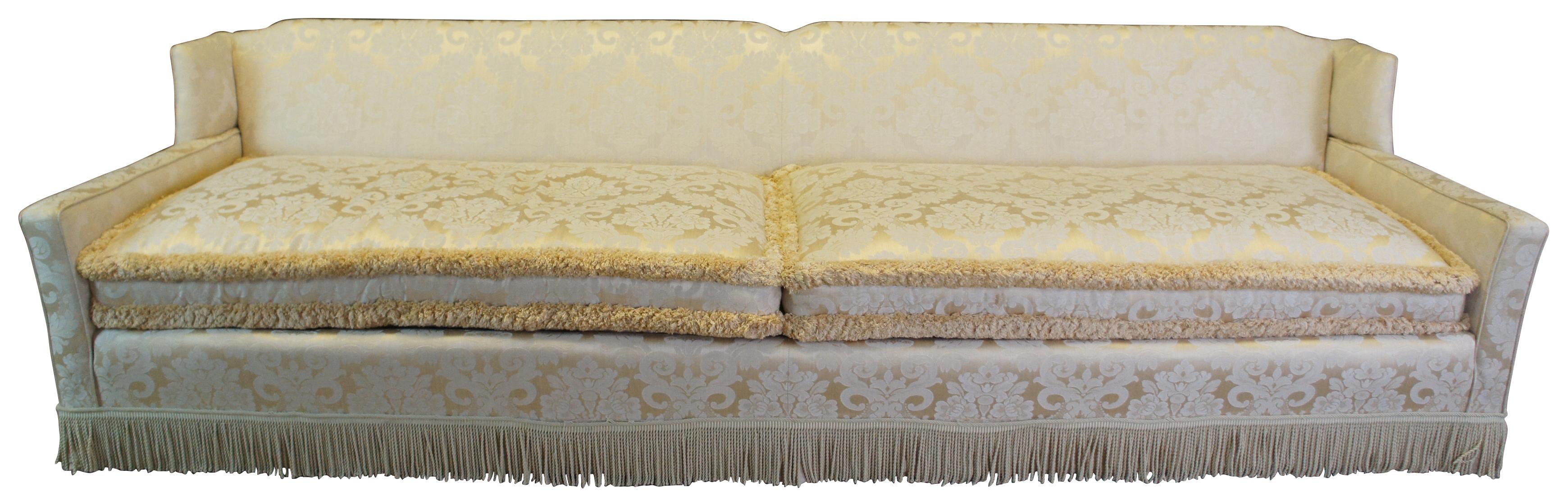 Stunning mid century track arm sofa. A rectangular frame upholstered in an old world off-white silk brocade fabric. Features large downfilled cushions, a 