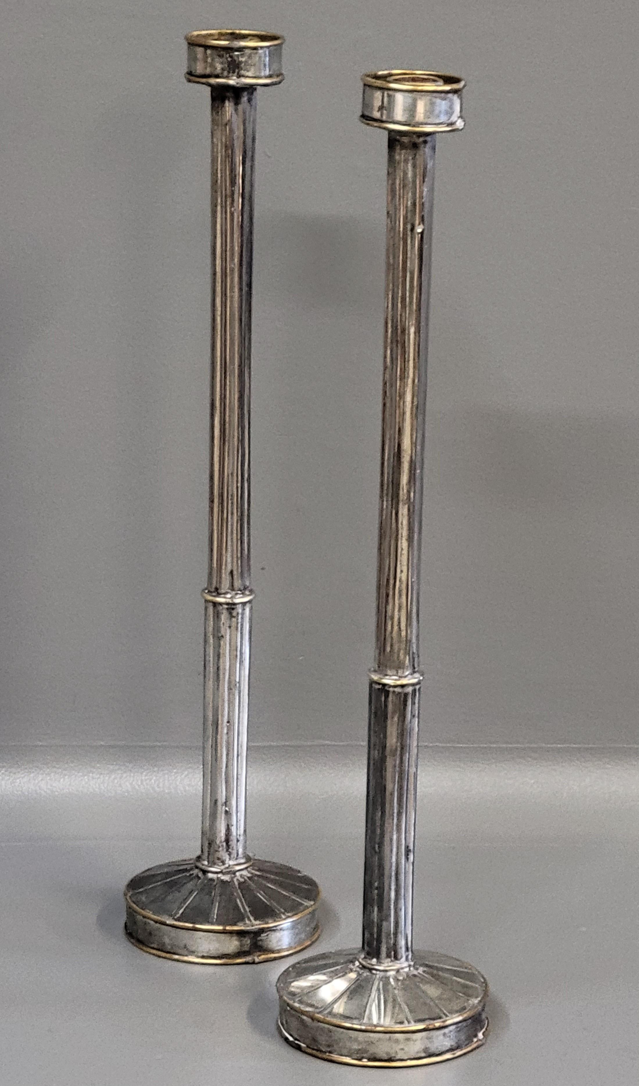 An elegant pair of fluted, tall, weighted tin and brass mid-century modern candlesticks. 