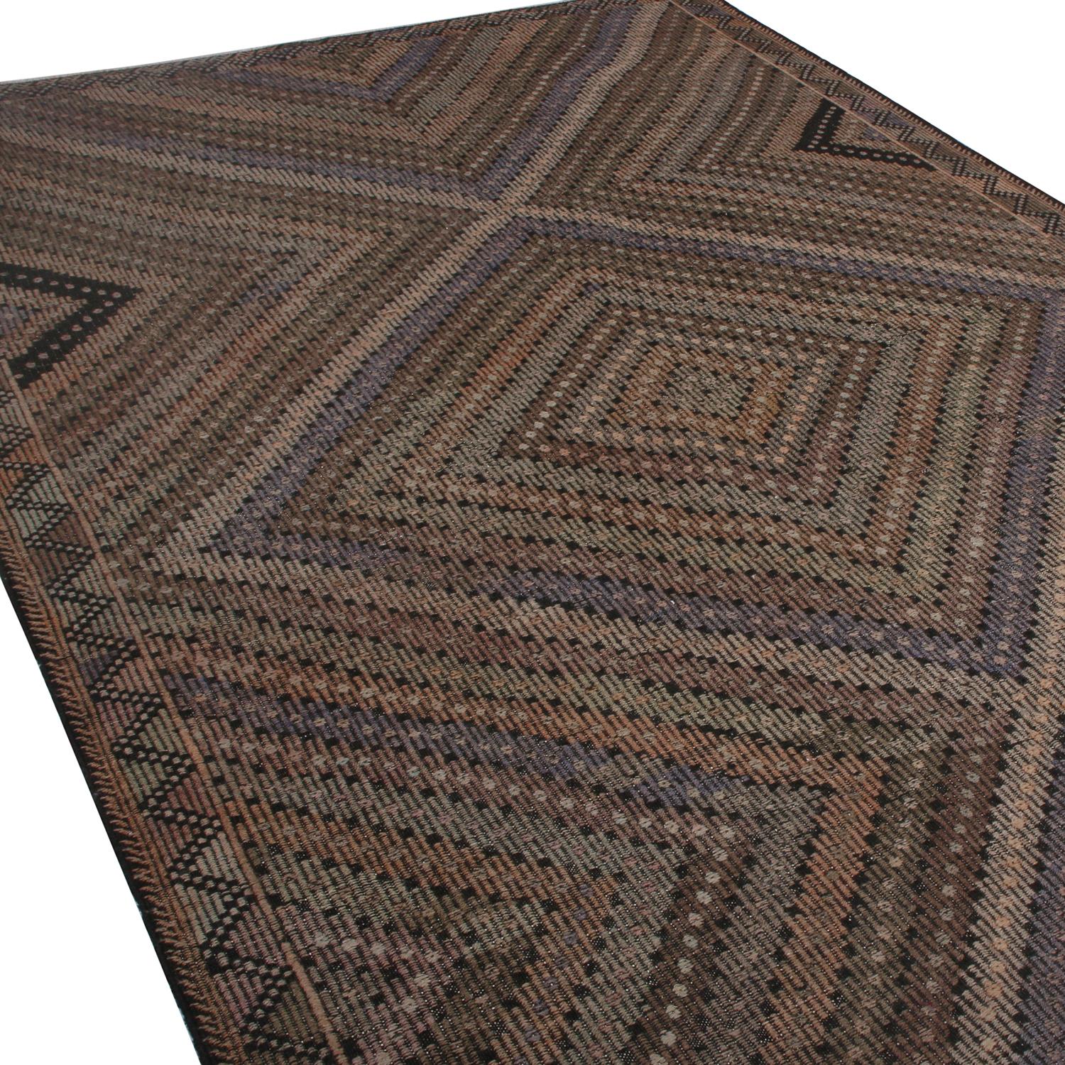 Handwoven in Turkey originating between 1950-1960, this vintage midcentury wool kilim rug enjoys a meticulous play of embroidery and flat weaving, uncommon and distinguishing of a select line from our recent additions to our collections. The
