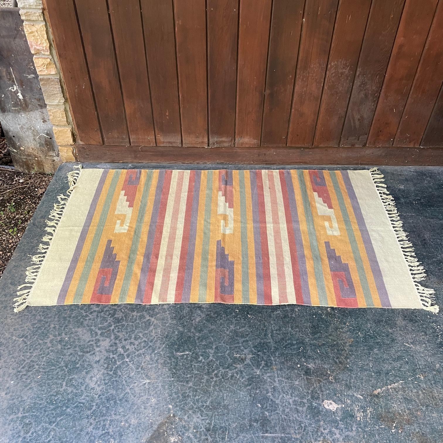 Supple, thin, and very smooth woven wool. A very calming palette of light earth tones. Estate fresh, a very well kept 1960s southwestern souvenir rug.