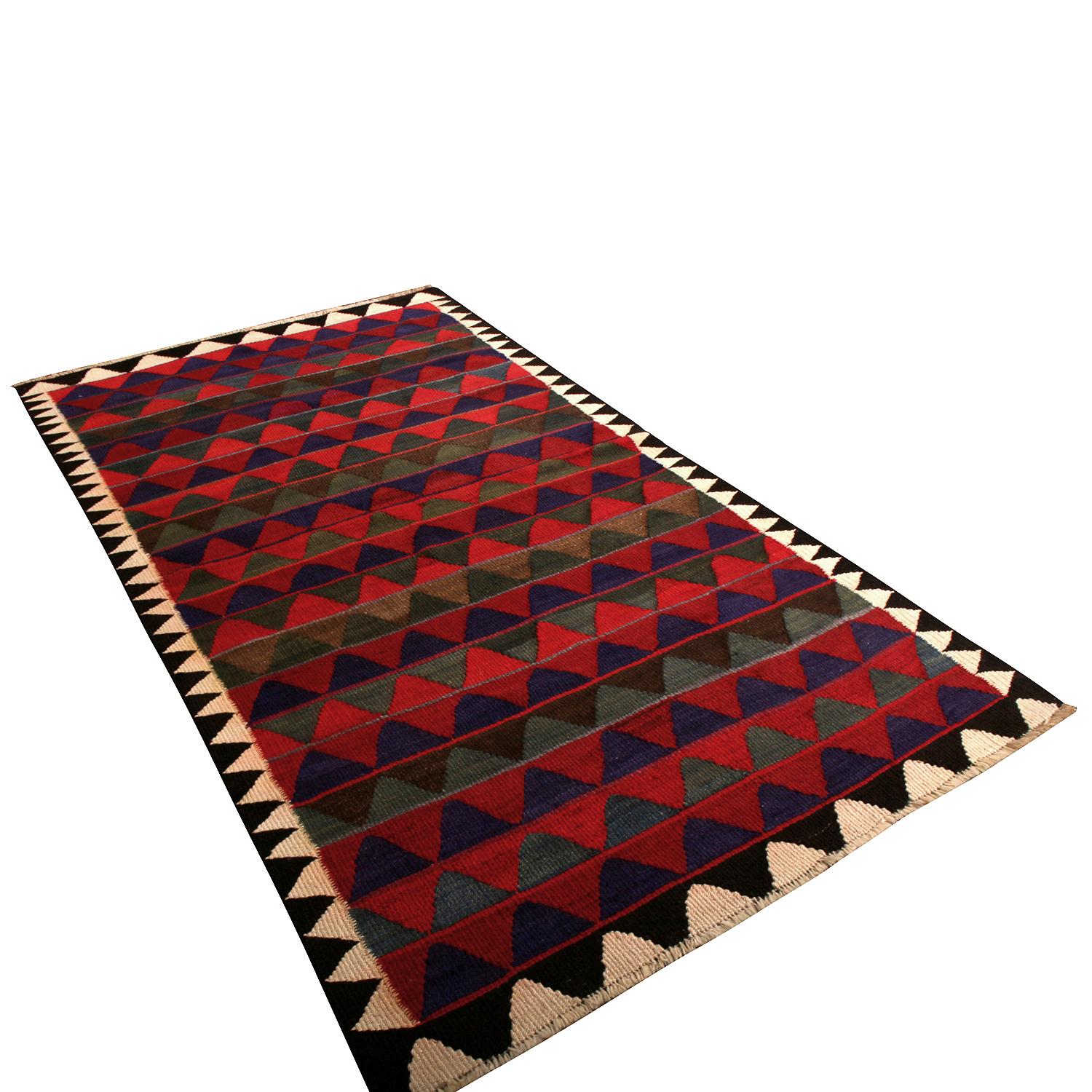 Handwoven in wool originating from Persia between 1950-1960, this vintage midcentury Kurdish Kilim rug enjoys both an appealing, versatile large size as well as a skillful play of colorway and pattern the most celebrated items of this Classic rug