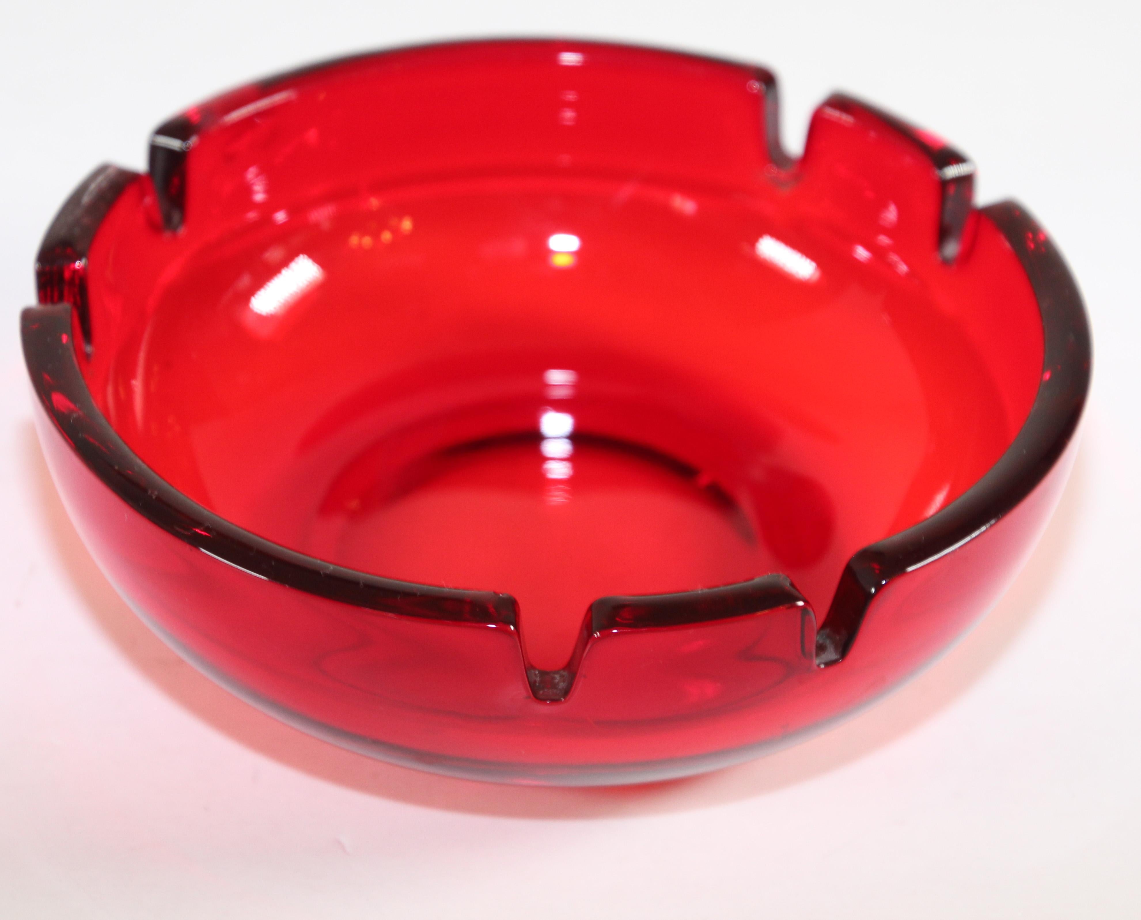 Vintage mid-century large round glass ruby red cigar ashtray
Mid-Century Modern glass ashtray circa 1960's – 1970's USA. 
Hand-made by Viking Art Glass in their beautiful ruby red color.
Large, heavy and stunningly beautiful. 
The vintage ruby