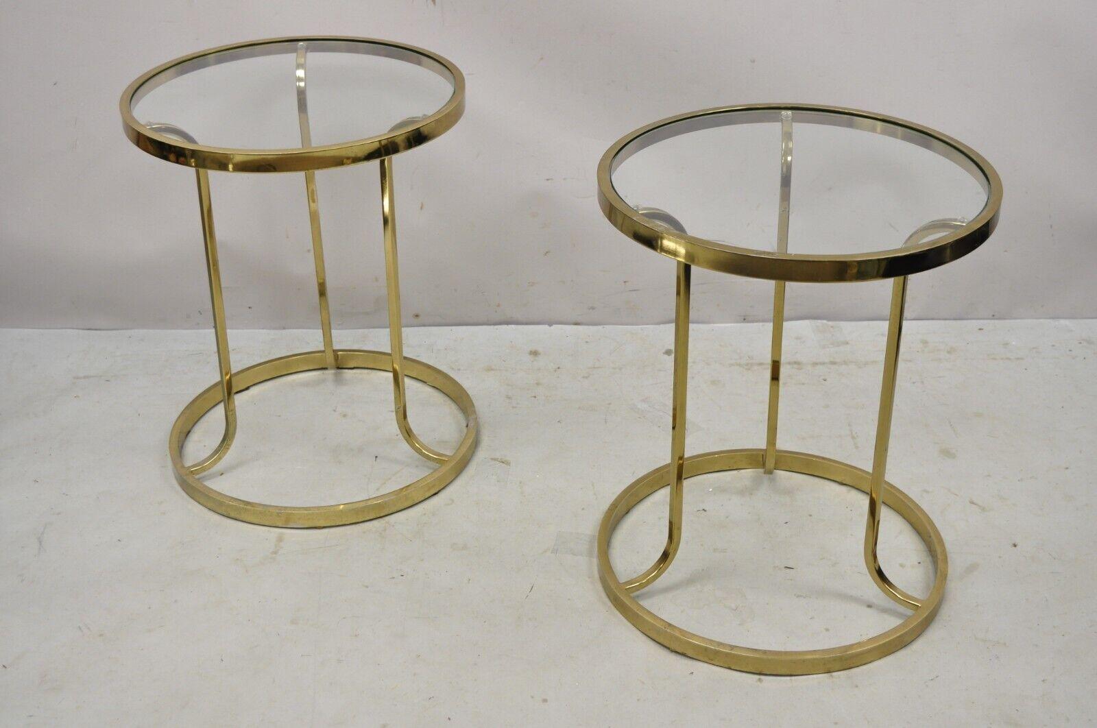 Vintage midcentury gold brass metal baughman style round side tables - a pair. Item features a sculptural metal base, round inset glass top, very nice vintage pair, clean modernist lines, great style and form. circa late 20th century. Measurements: