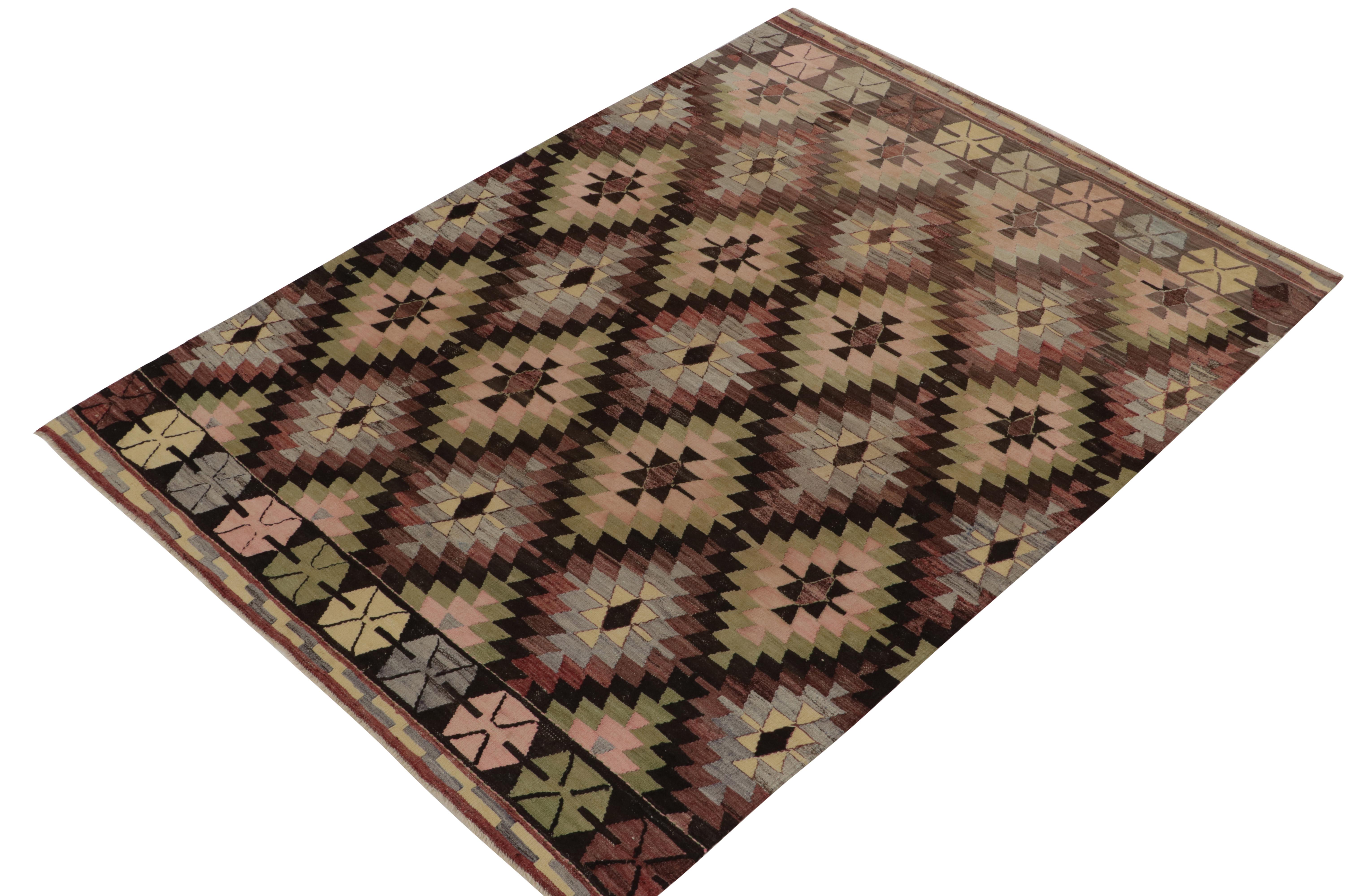 Originating from Turkey circa 1950-1960, a 6x8 vintage kilim rug from our flatweave selections. Handwoven in wool, the rug enjoys rippling geometry in  the most unusual colors of green, blue, bordeaux-purple, black, and pink. Relishing a pleasing