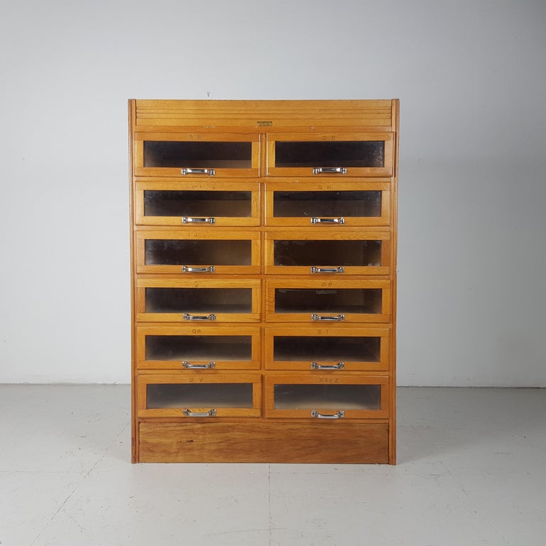 12-drawer haberdashery shop cabinet from a general store in Leeds.

With 12 glass fronted drawers with metal handles.

Approximate dimensions:

Width 92cm

Depth 54cm

Height 125cm

Drawers 40 x 44 x 13cm.

Overall, in good vintage