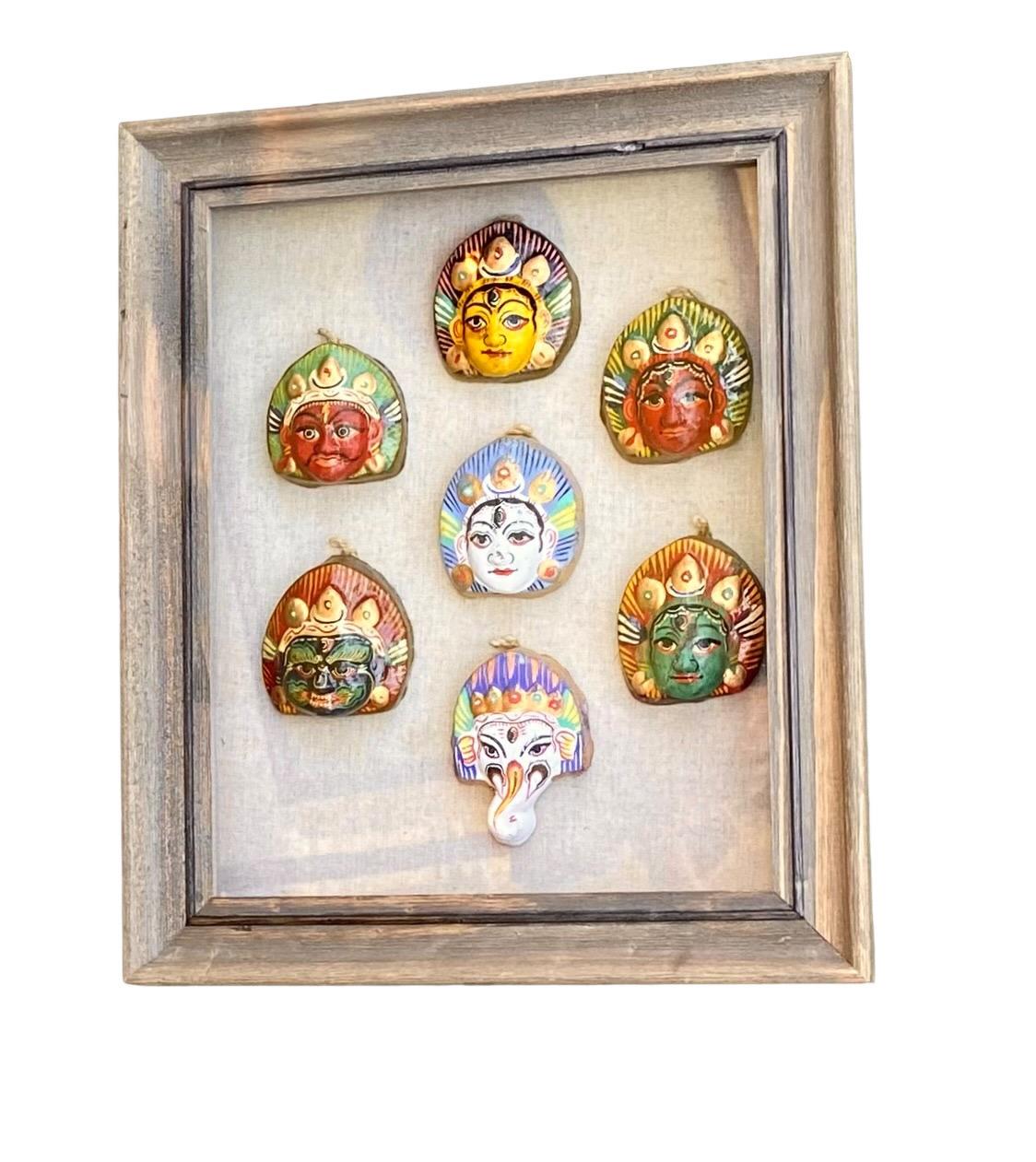 Vintage midcentury handmade and hand painted shiva third eye sculptures framed in a beautiful shadow box. This piece features seven handmade and hand painted Shiva faces with distinct third eyes. They are mounted in a shadow box with a linen fabric